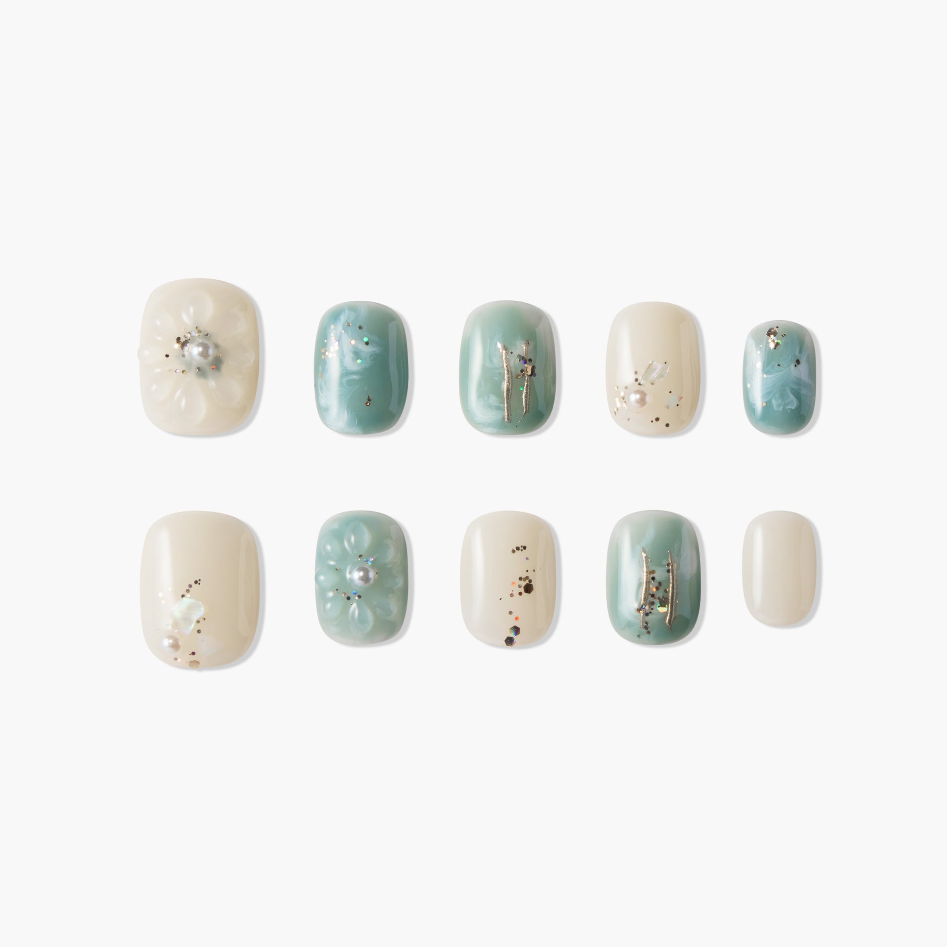 Handmade press-on nails in teal and ivory with pearl, flower, and gold foil accents.
