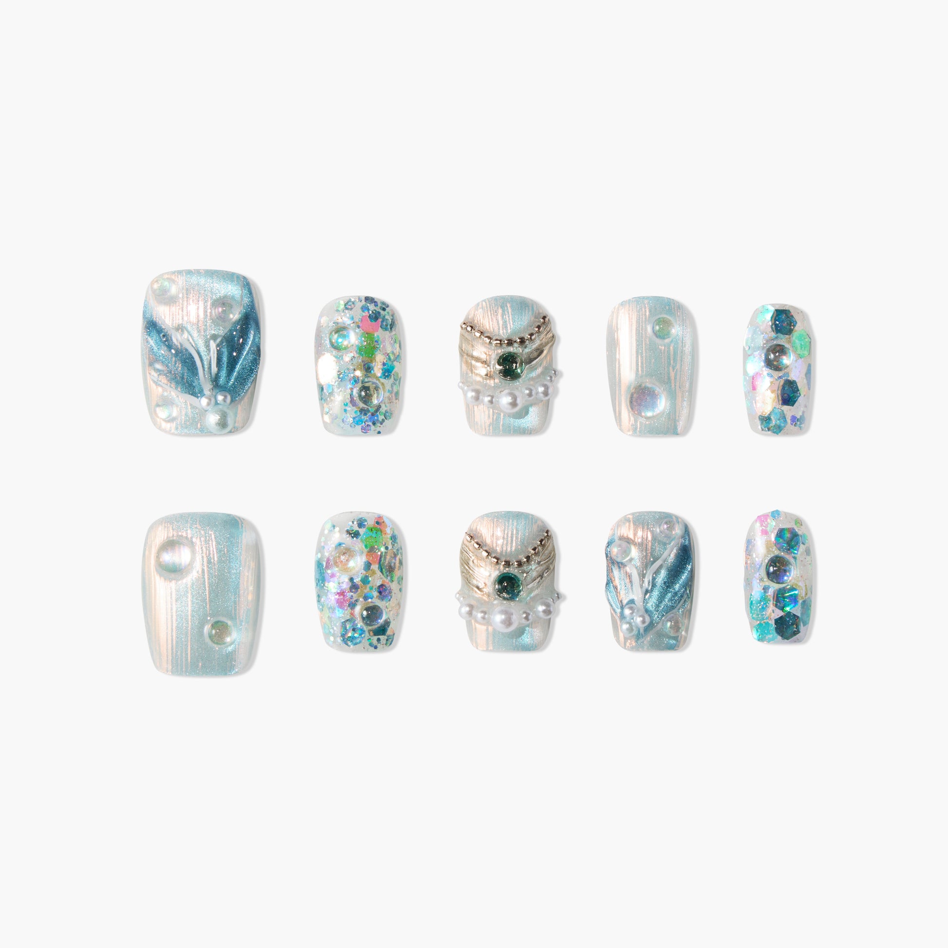 Blue shimmery press-on nails with pearl, gemstone, and glitter accents, mermaid-inspired design.