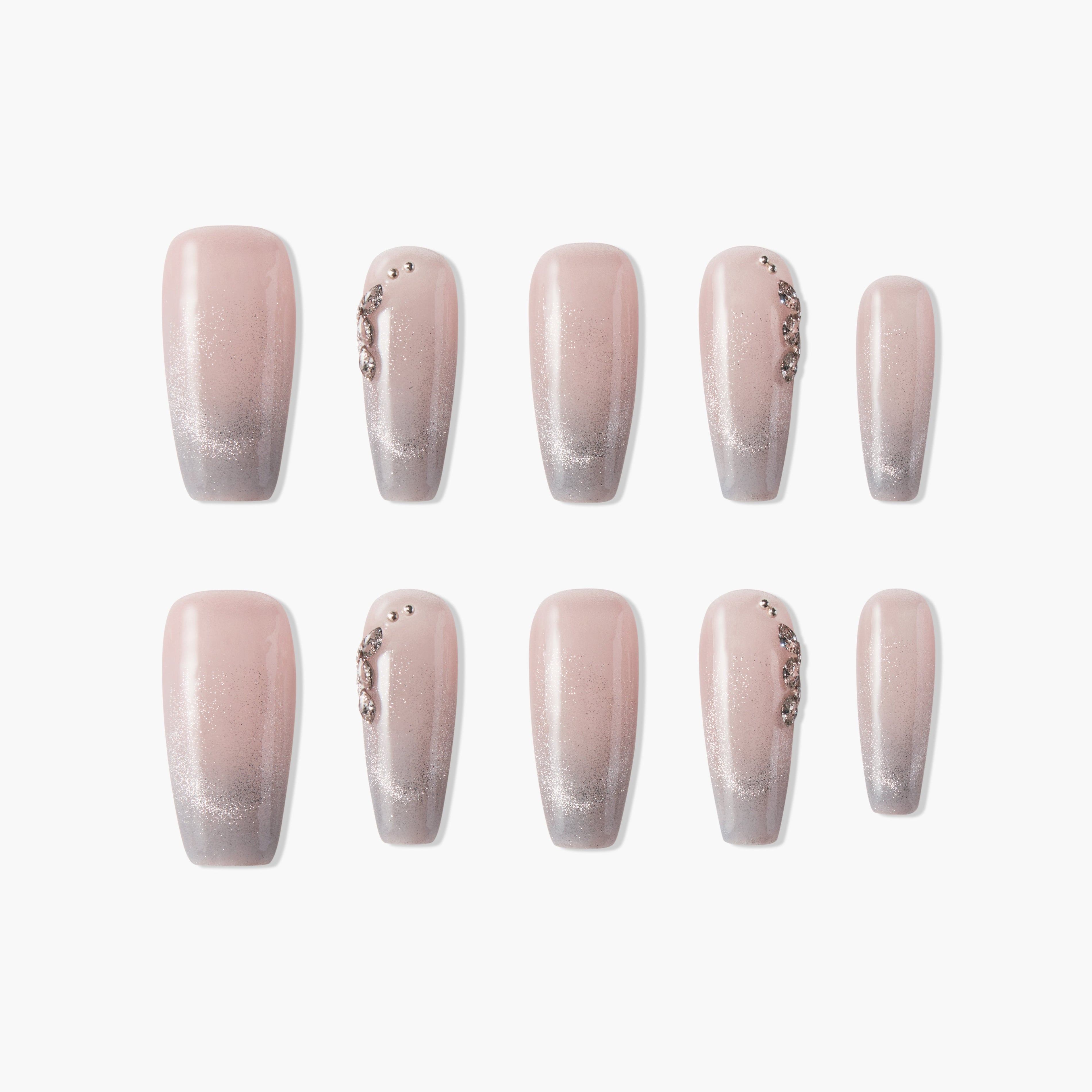 Set of ombre pink and silver glitter press-on nails with rhinestone accents, salon style