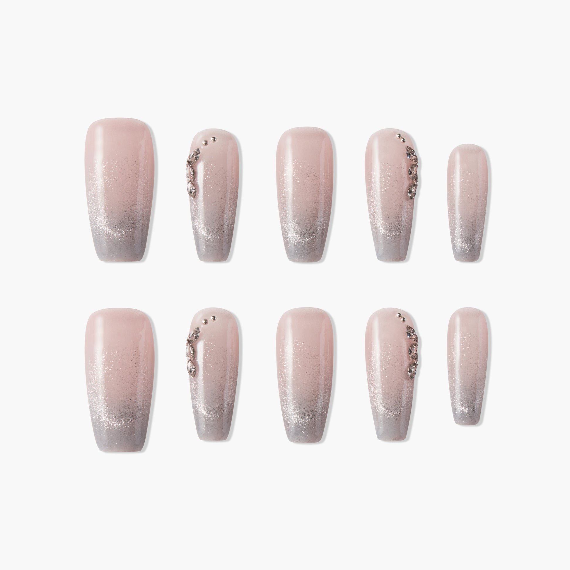 Set of ombre pink and silver glitter press-on nails with rhinestone accents, salon style