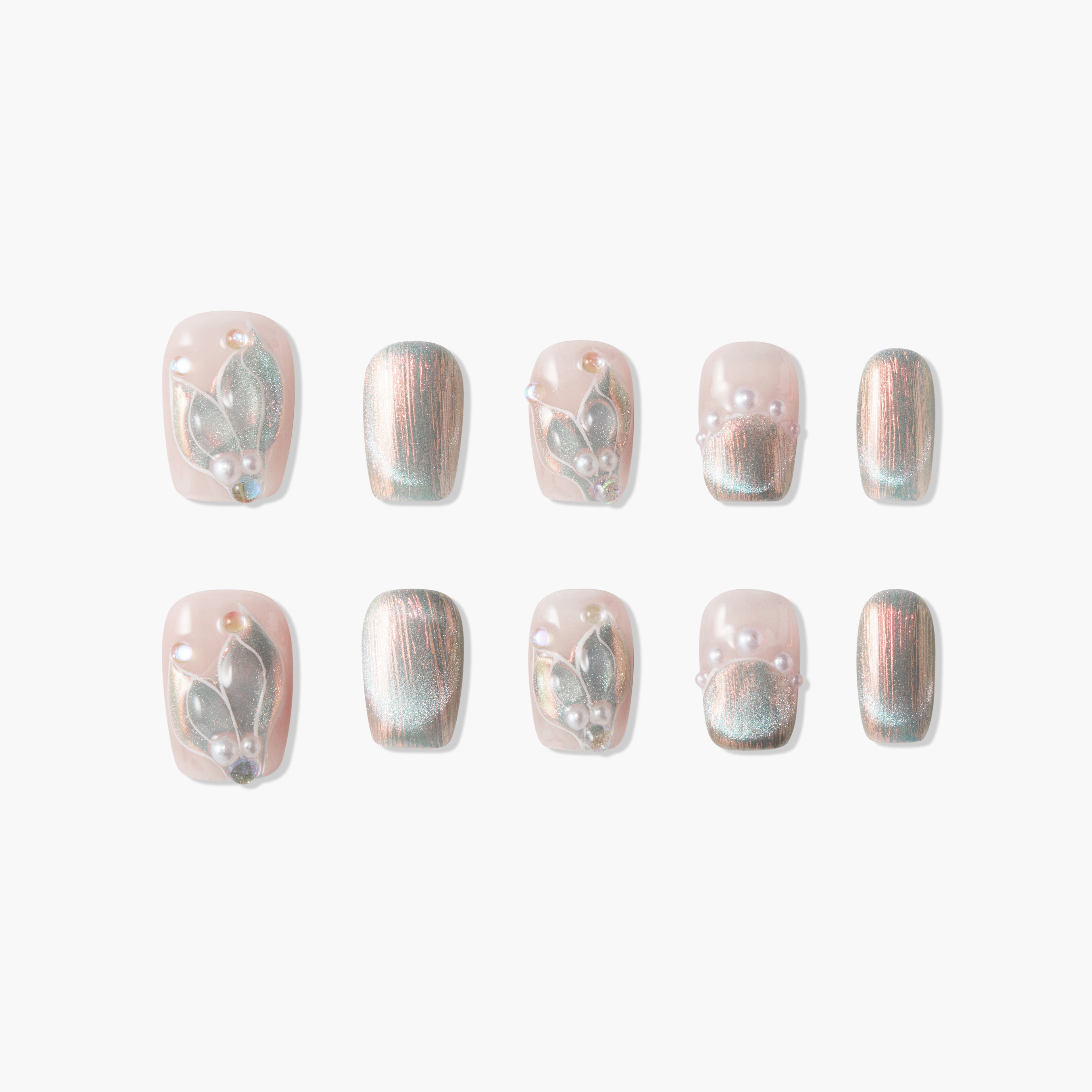 Handmade press-on nails with a shimmery pink base, pearl accents, and 3D floral designs