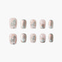 Handmade press-on nails with a shimmery pink base, pearl accents, and 3D floral designs
