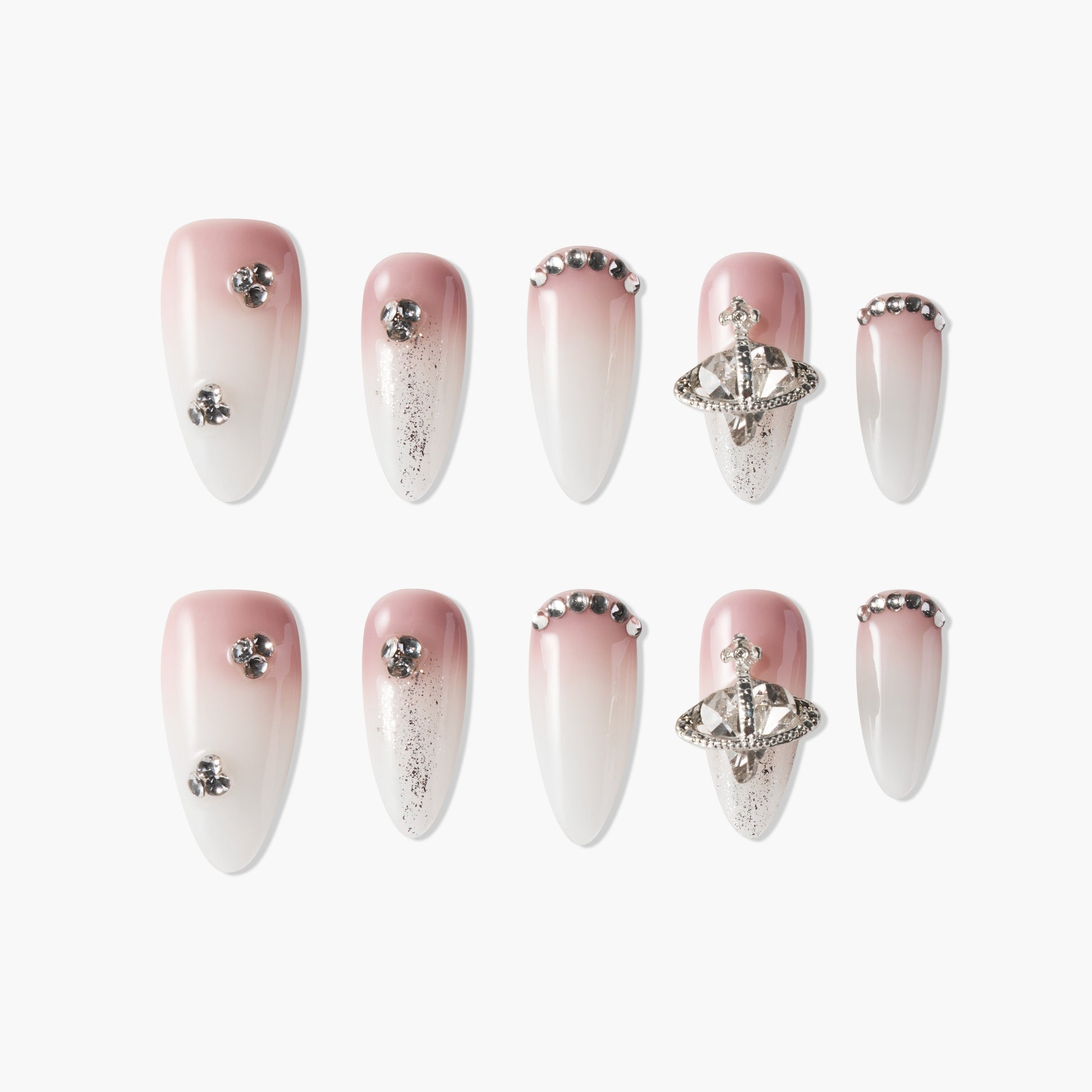 Ombre pink and white press-on nails with rhinestones, glitter, and 3D silver embellishments