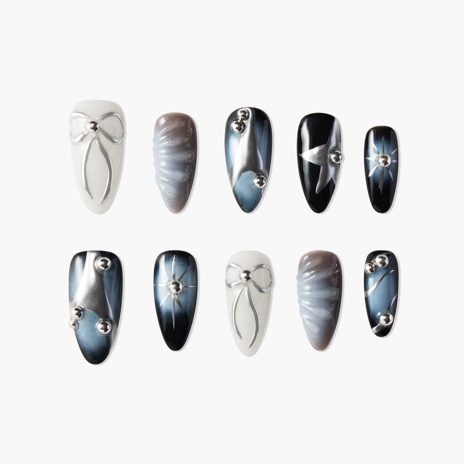 Handmade press-on nails set with metallic bows, abstract patterns, and silver accents in blue, white, and black tones.