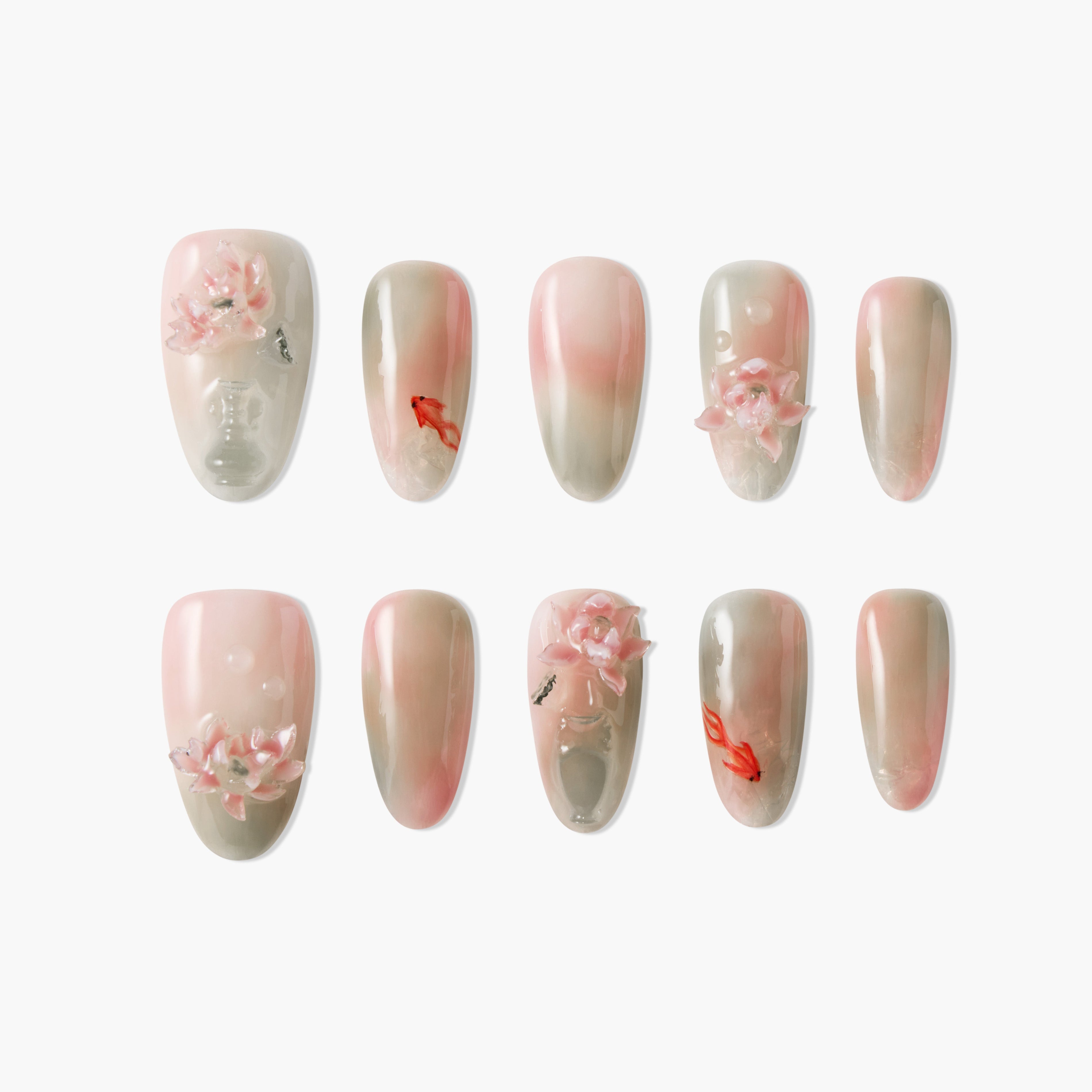 Pink and nude ombre press-on nails with 3D floral accents and koi fish designs