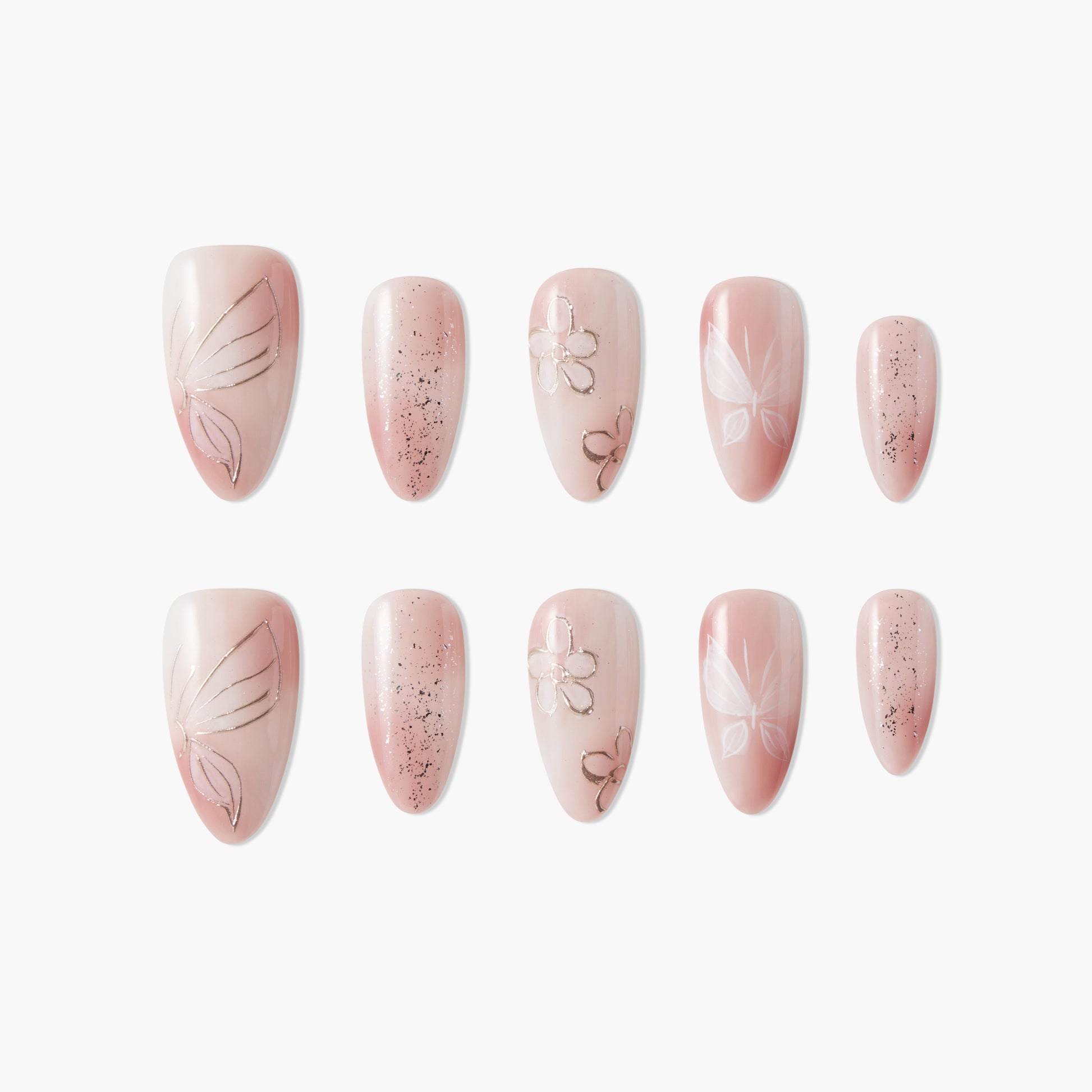 Handmade press-on nails in blush pink with butterfly, floral, and glitter designs, arranged on white background.