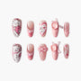 Handmade press-on nails with cute pink cat, hearts, pearls, and bow designs