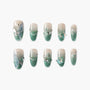 Green ombre press-on nails with butterfly, pearl, and gem 3D nail art accents