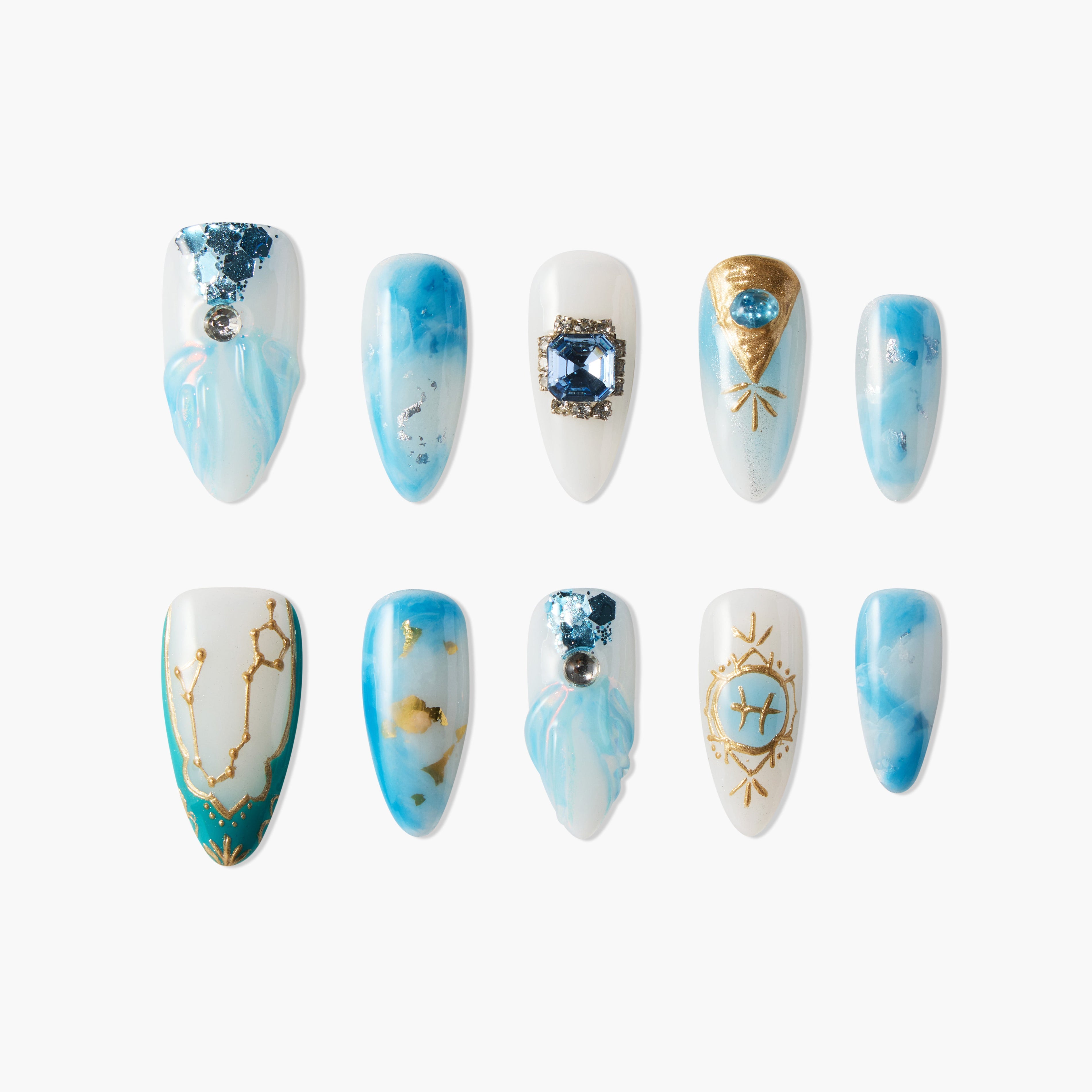 Blue and white press-on nails with gemstone accents, gold constellation and zodiac designs