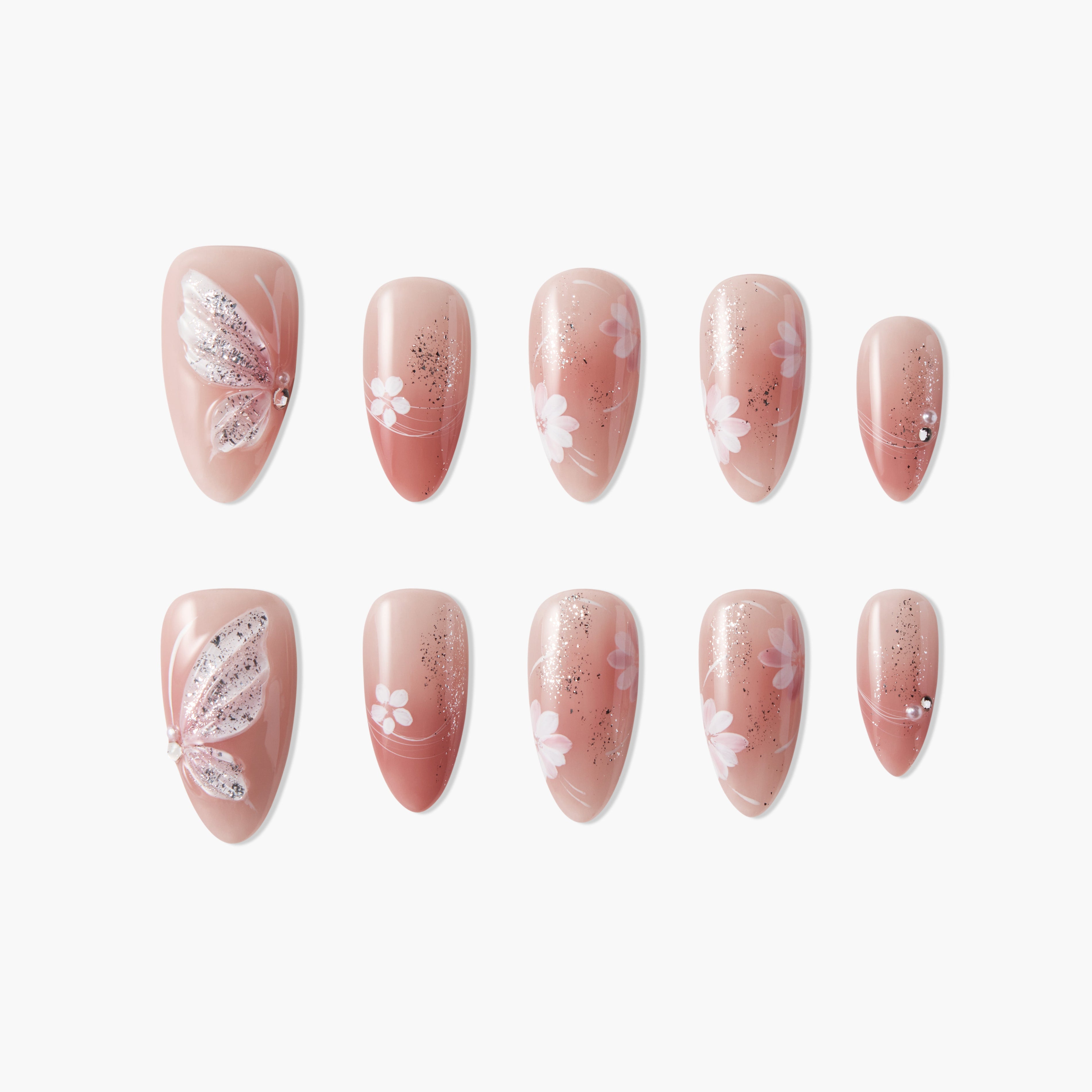 Pink press-on nails with butterfly, glitter, rhinestones, and floral nail art design