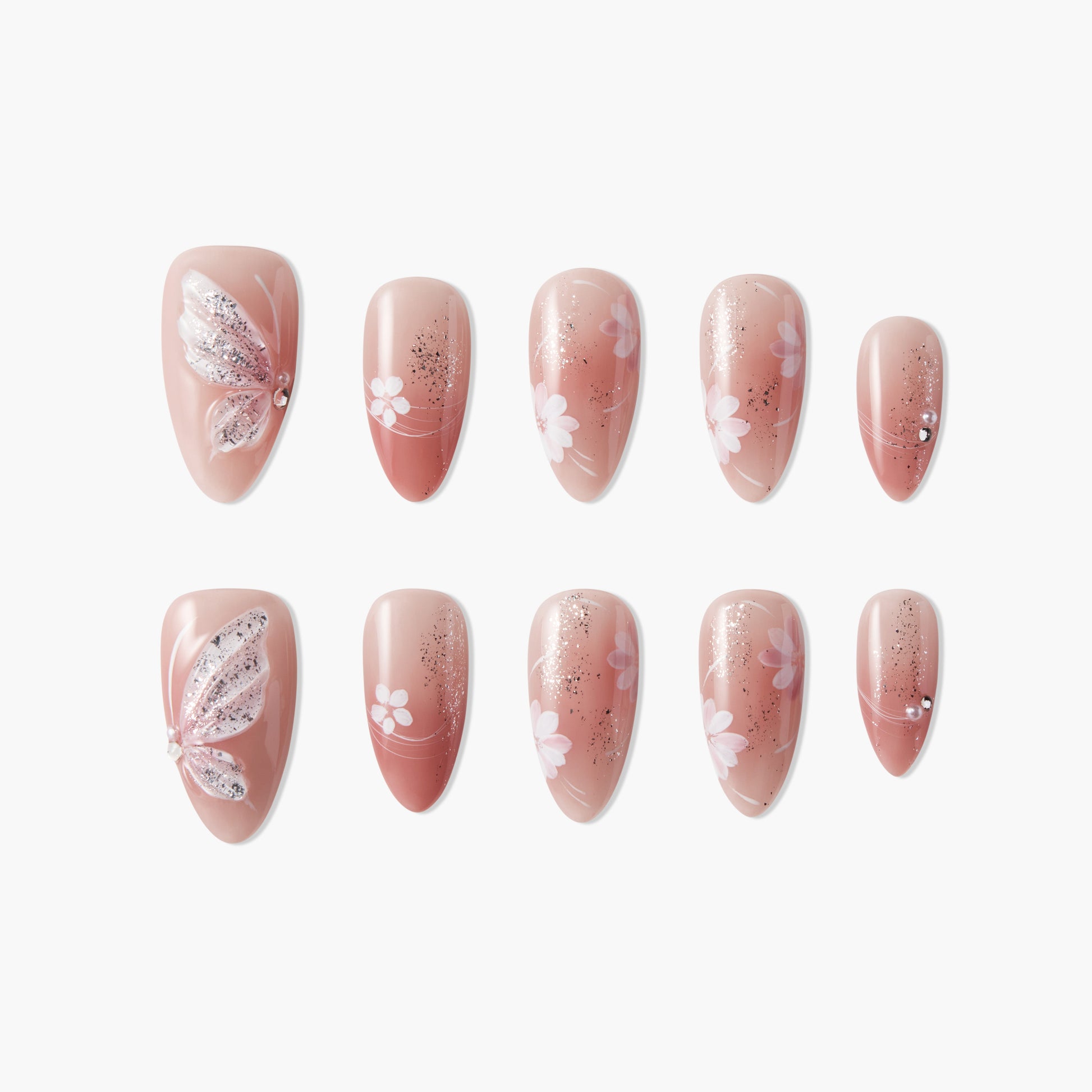 Pink press-on nails with butterfly, glitter, rhinestones, and floral nail art design