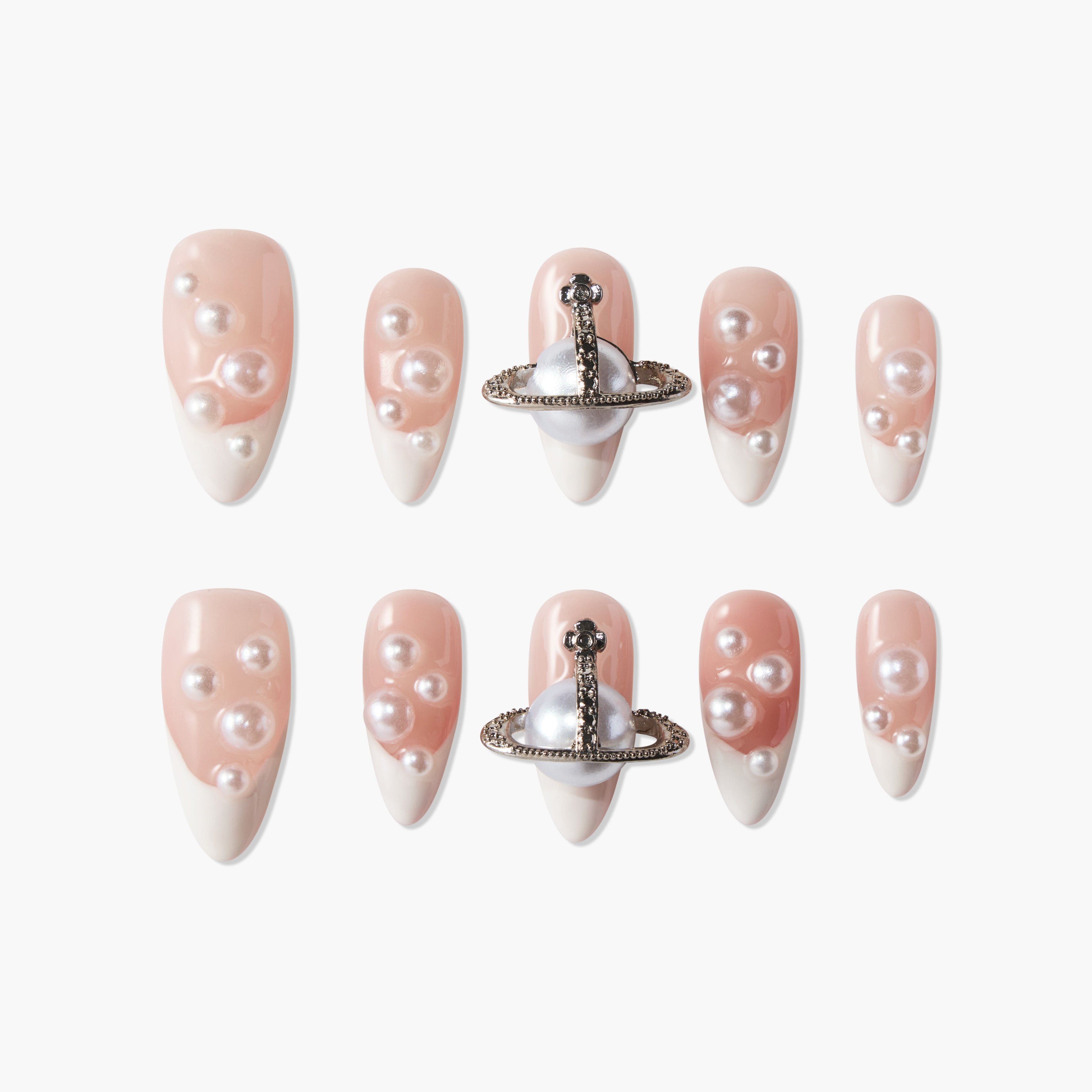 Handmade press-on nails with pearl accents and metallic 3D embellishments on nude French tips