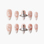 Handmade press-on nails with pearl accents and metallic 3D embellishments on nude French tips