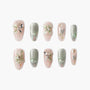 Handmade press-on nails with 3D floral designs, pearls, crystals, and butterfly accents in pink and green.