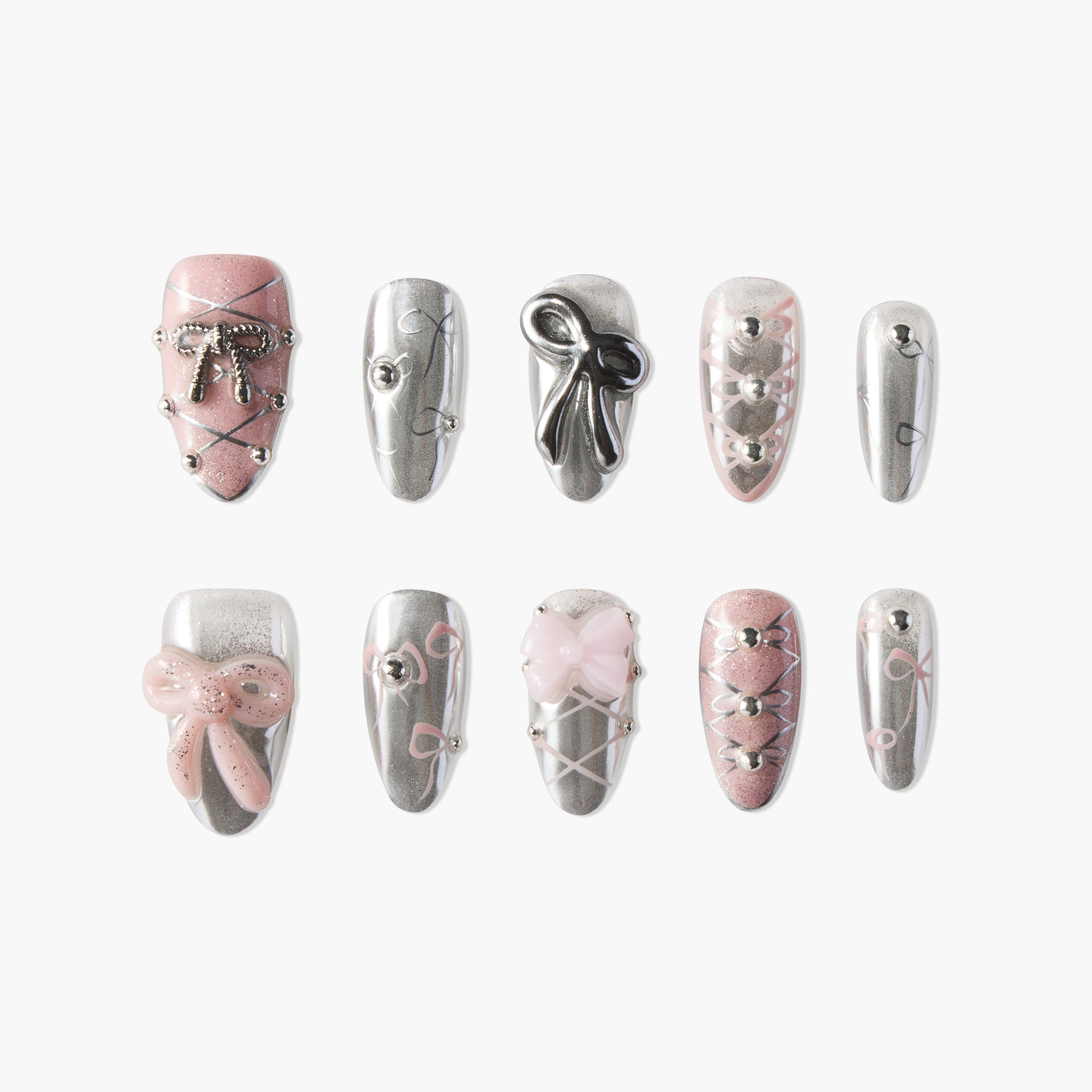 Handmade press-on nails with pink and silver bows, gems, and crisscross designs on white background.