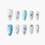 Handmade press-on nails with blue and white gradient, bow, bunny, and gem accents
