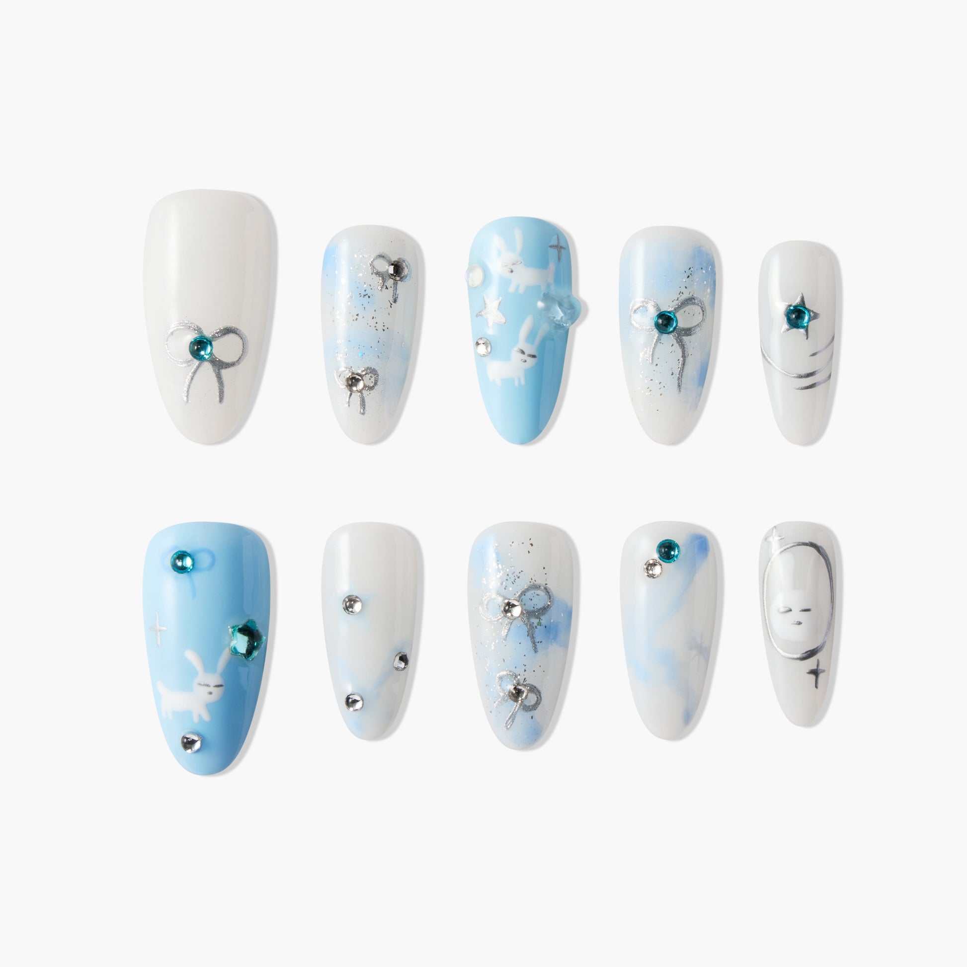 Handmade press-on nails with blue and white gradient, bow, bunny, and gem accents