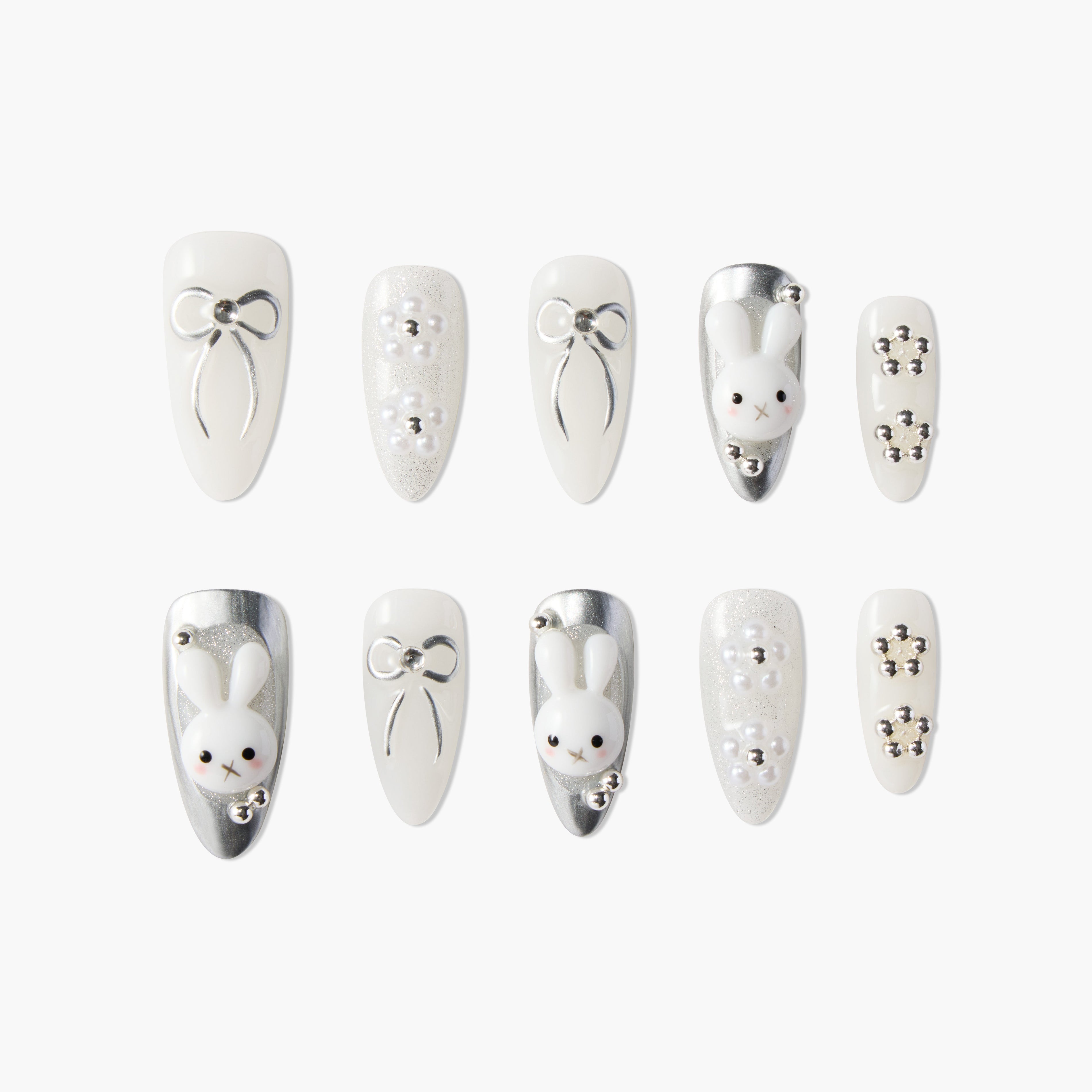 White and silver press-on nails with 3D bows, pearls, and cute bunny designs