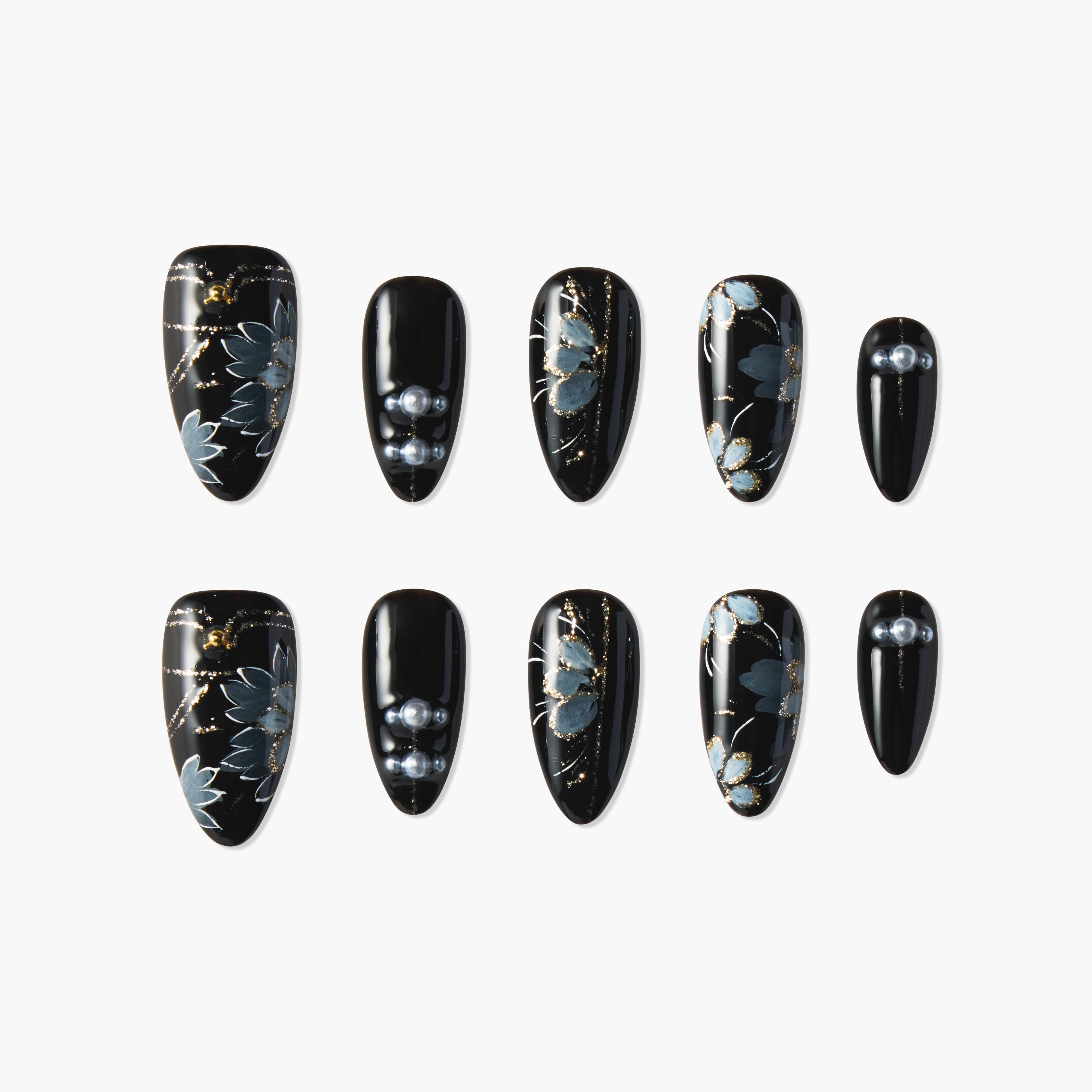 Black press-on nails with blue floral designs, gold accents, and pearl embellishments