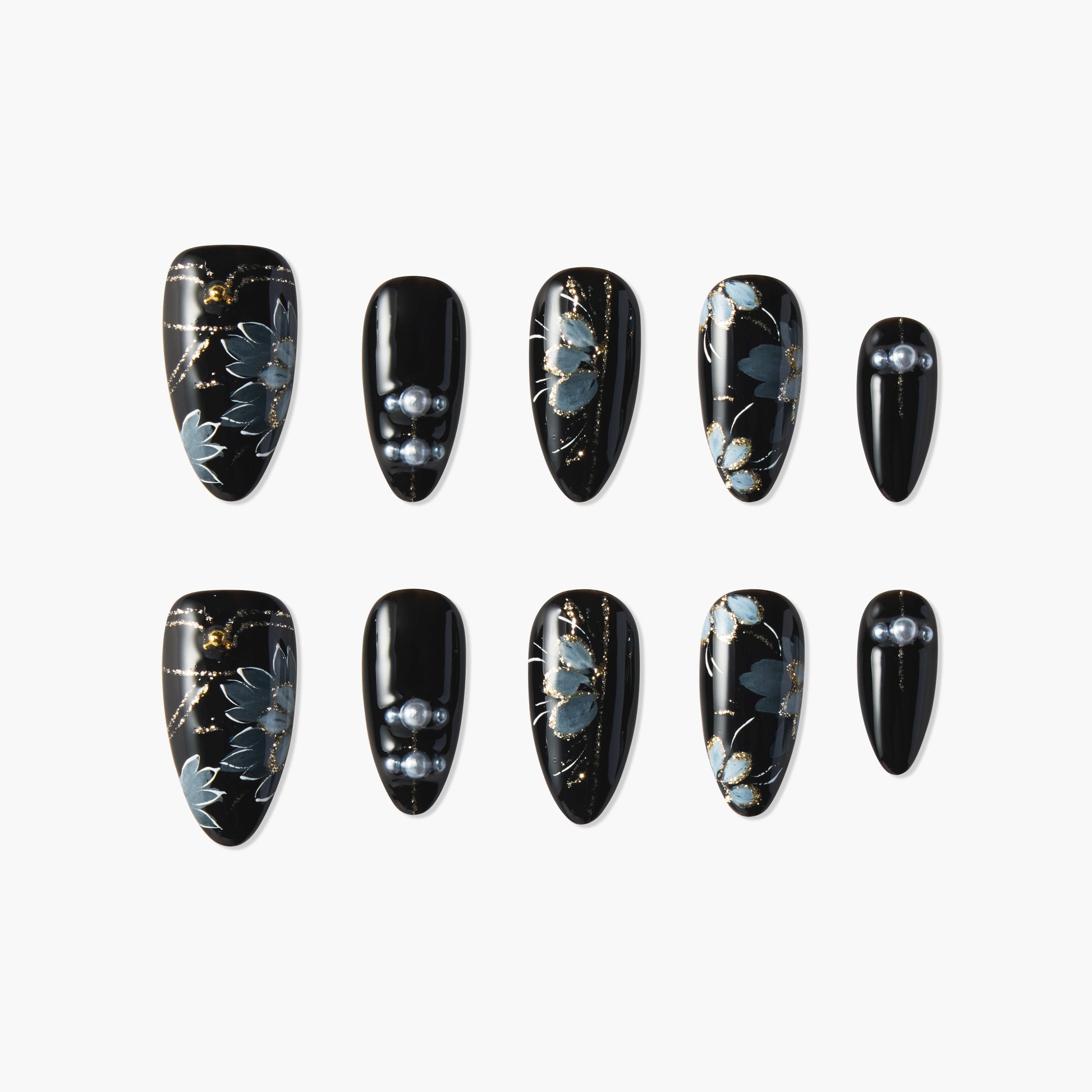 Black press-on nails with blue floral designs, gold accents, and pearl embellishments