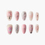 Cute pink press-on nails with cartoon bear, bows, hearts, pearls, and rhinestone accents