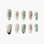 Handmade press-on nails with green marble, gold celestial designs, gems, and constellation art