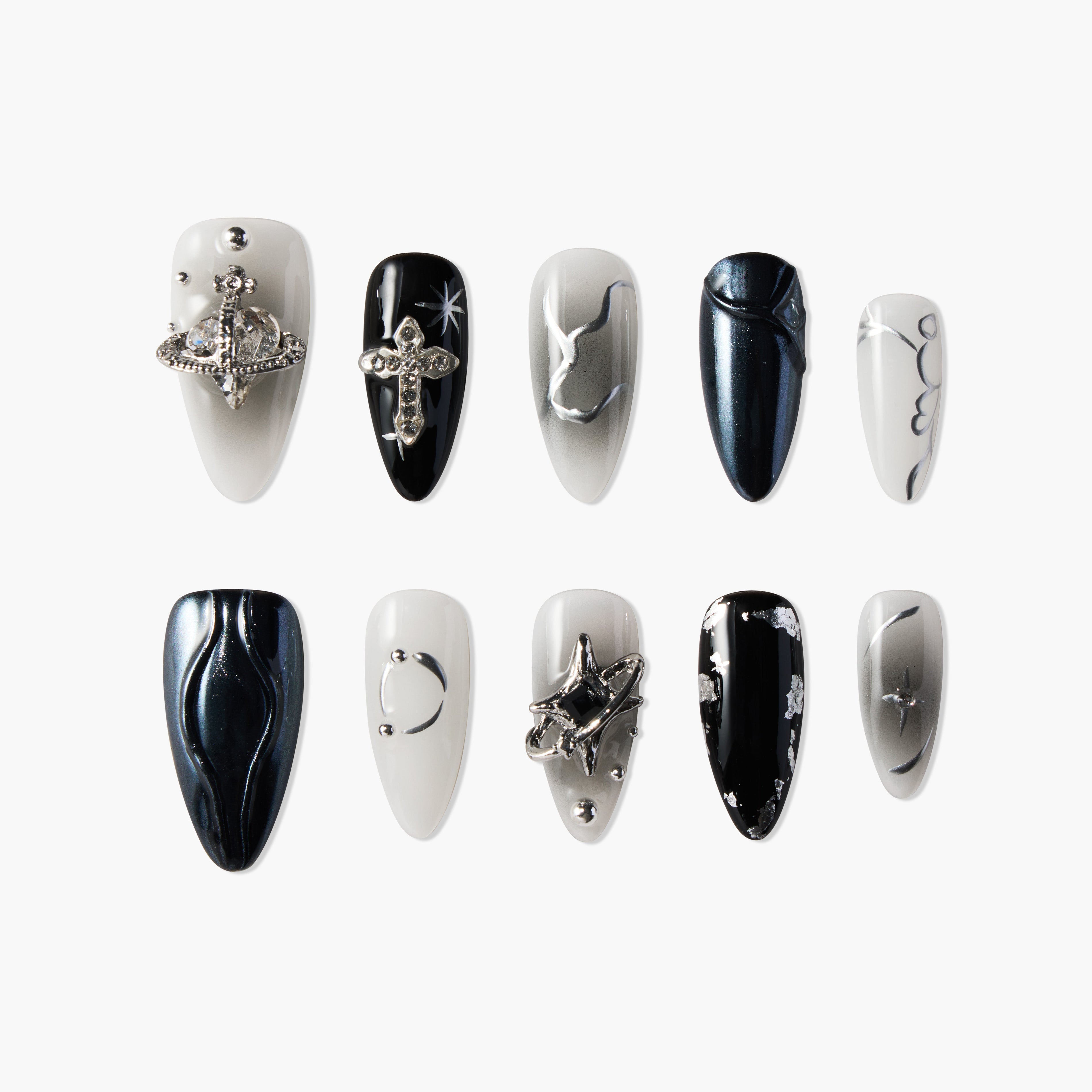 Black and white handmade press-on nails with metallic 3D charms, abstract and celestial designs.