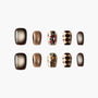 Handmade press-on nails in brown, gold glitter, and diamond pattern designs