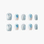 Handmade press-on nails with glittery blue dolphin designs and light blue shimmer accents