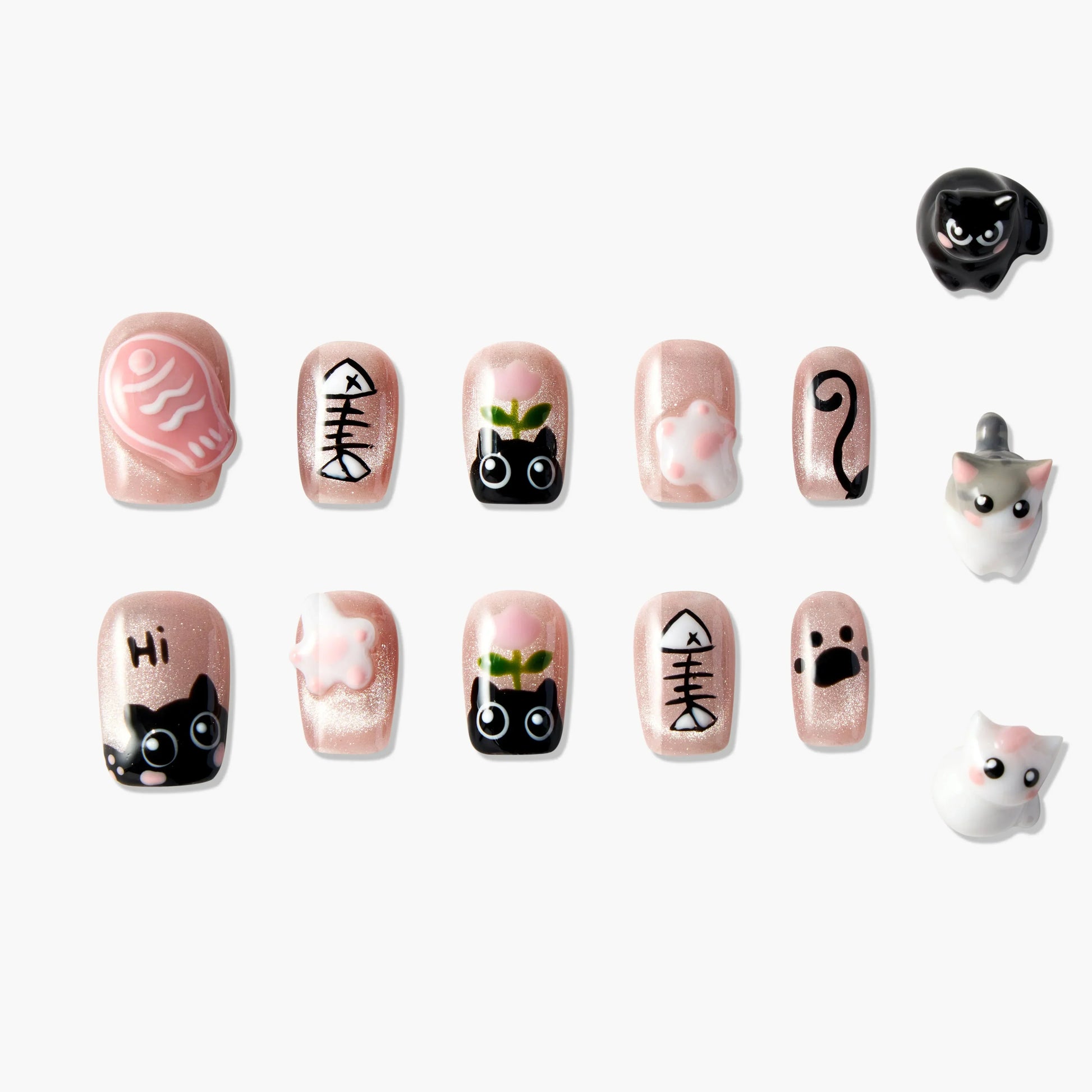 Cute cat-themed press-on nails with fishbone, paw, and cartoon cat designs on pink base.