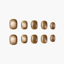 Set of gold glitter press-on nails, oval shape, displayed on a white background.