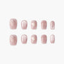 Set of pink shimmer press-on nails with glossy heart designs and small heart accents