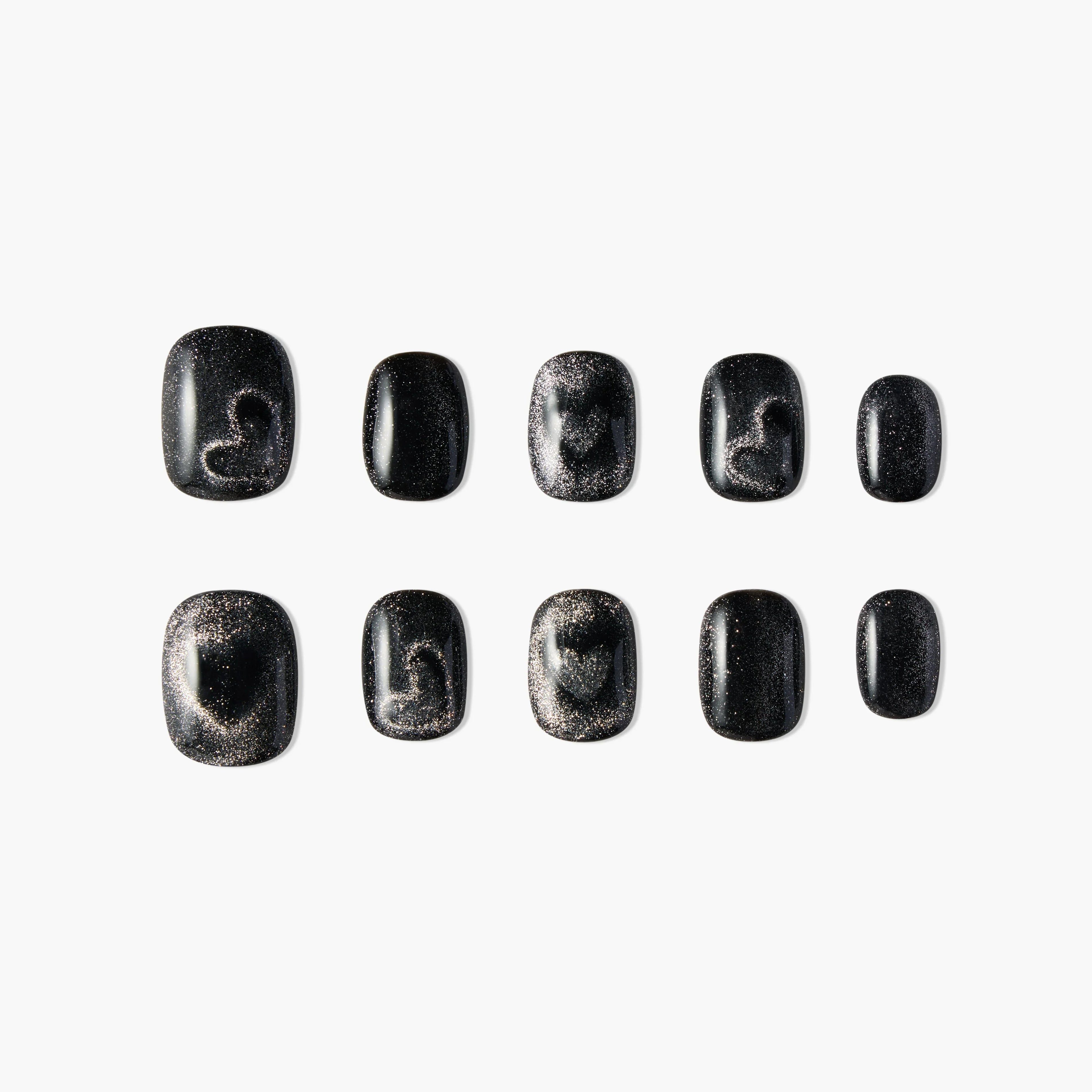 Set of black press-on nails with silver glitter and abstract heart accents, displayed on white background.