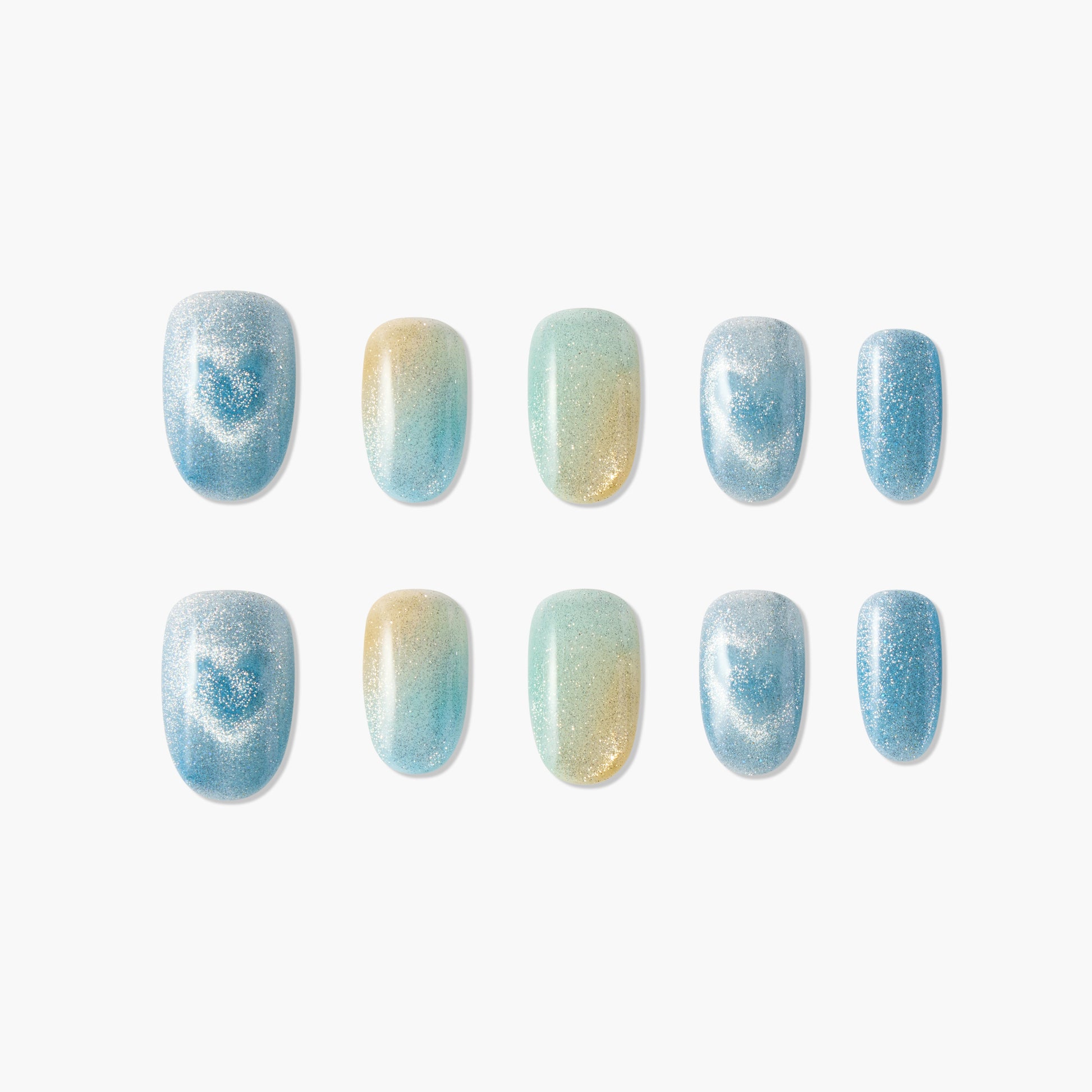Set of ten glitter ombre press-on nails in blue, yellow, and teal on white background