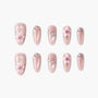 Pink press-on nails with pearl shimmer, floral designs, rhinestones, and 3D embellishments