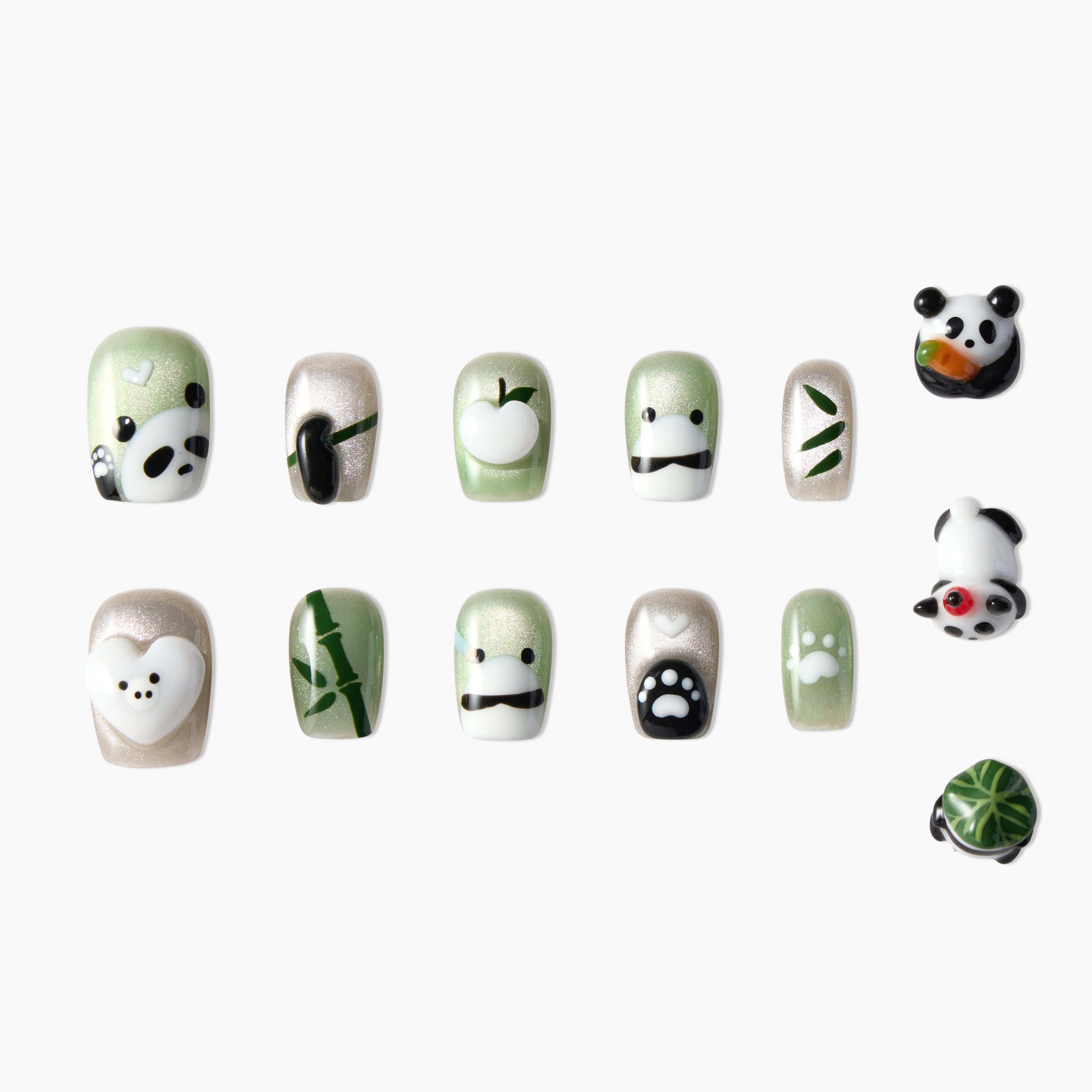 Handmade press-on nails with cute panda, paw print, and bamboo designs in green and white.