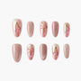 Pink press-on nails set with cherry nail art and glossy nude finish on a white background.
