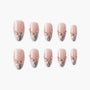 Set of pink press-on nails with silver glitter tips and rhinestone accents on white background