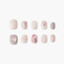 Handmade press-on nails in pink, white, and silver marble design with glossy finish