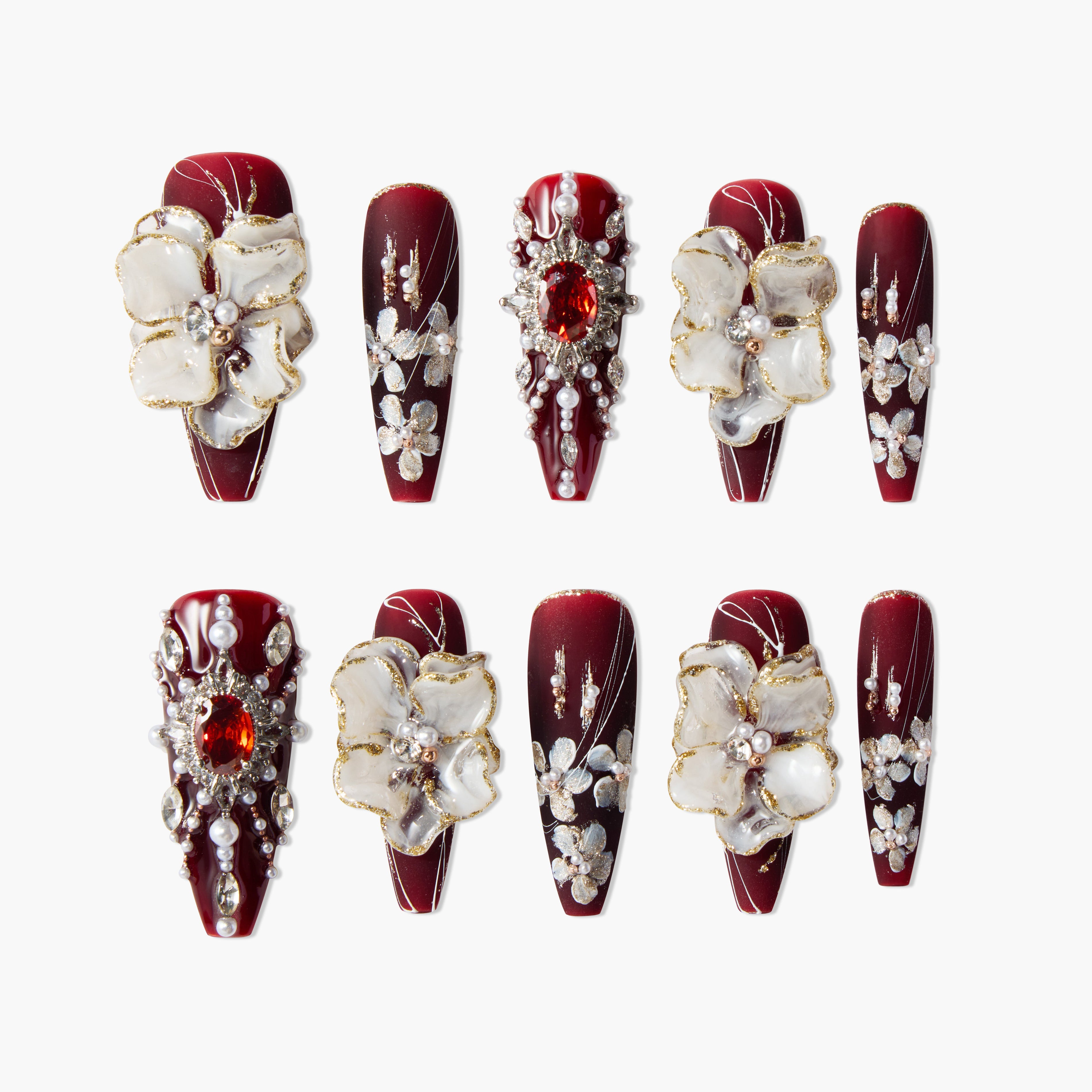 Burgundy press-on nails with 3D floral accents, pearls, and rhinestone designs