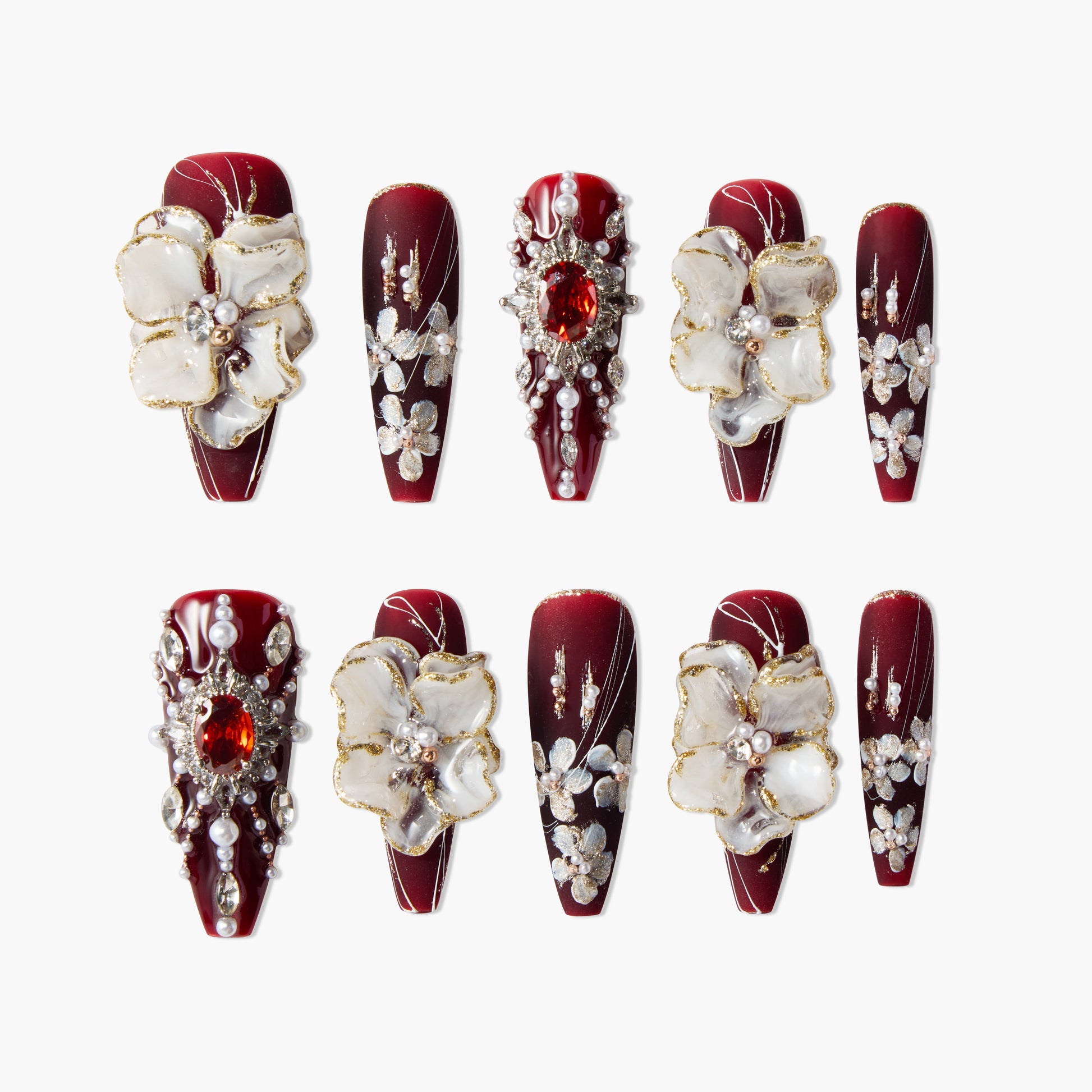 Burgundy press-on nails with 3D floral accents, pearls, and rhinestone designs