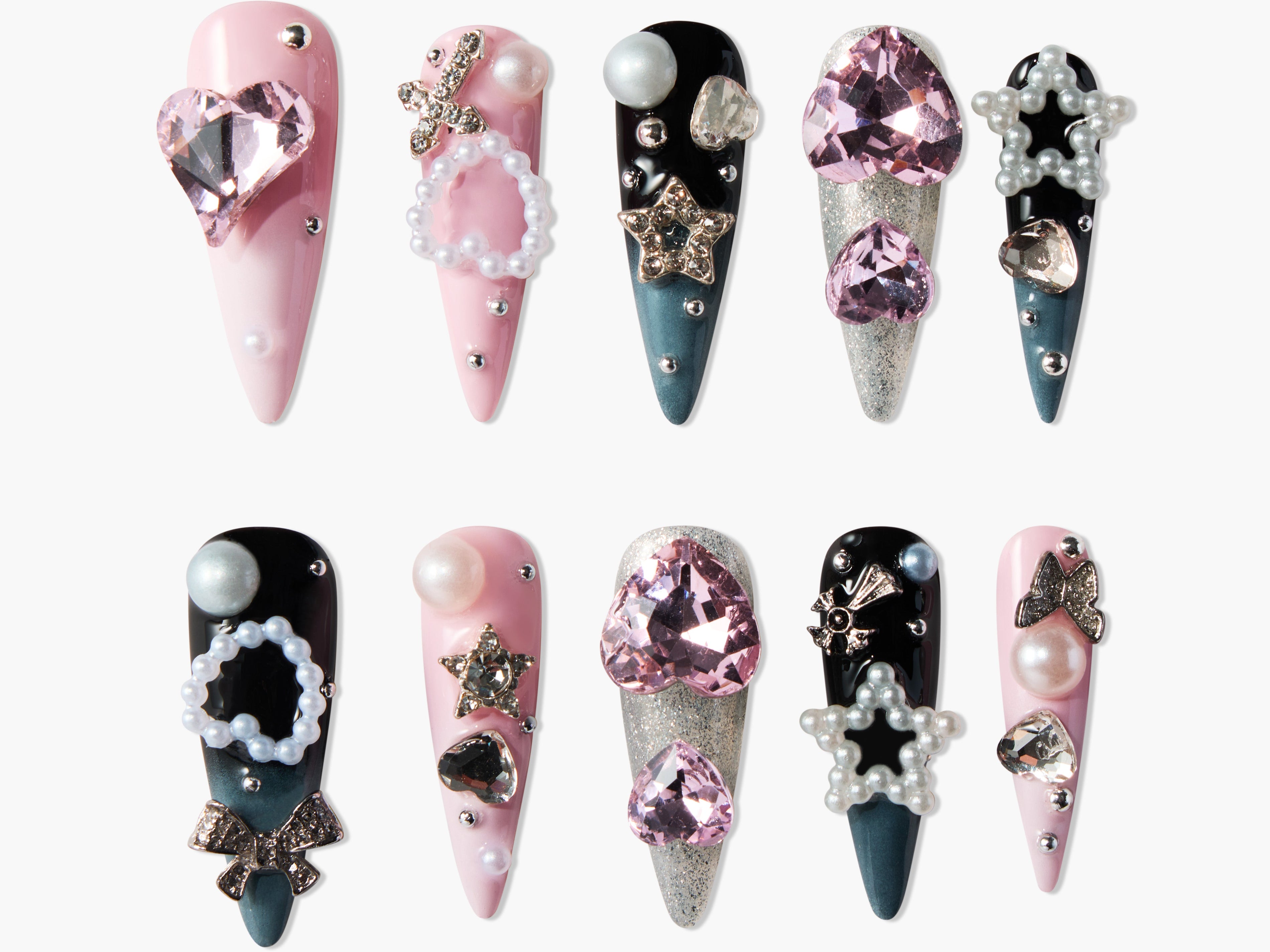 Handmade press-on nails with pink, black, and glitter designs, adorned with gems and pearls