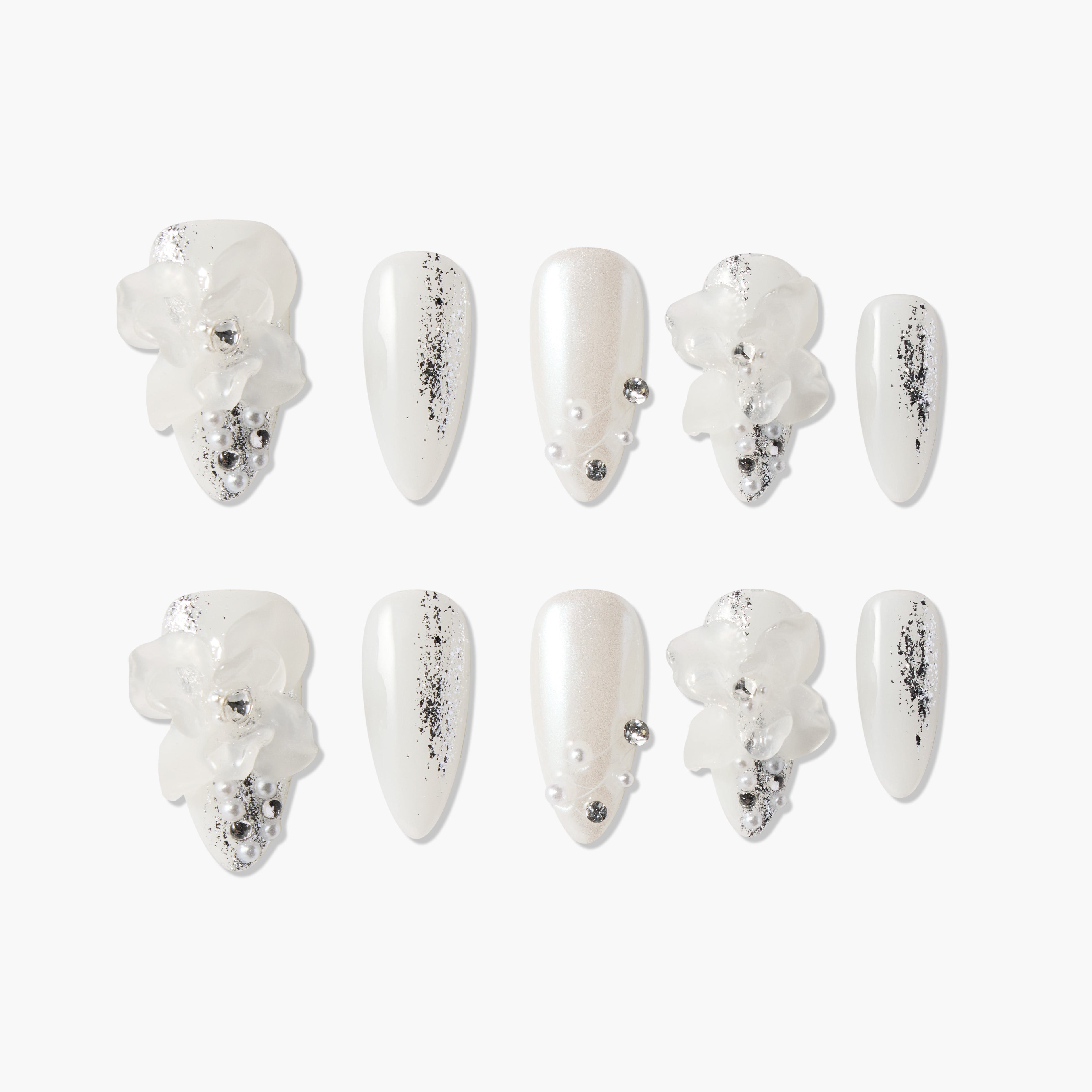 White press-on nails with 3D floral accents, silver glitter details, and pearl embellishments.