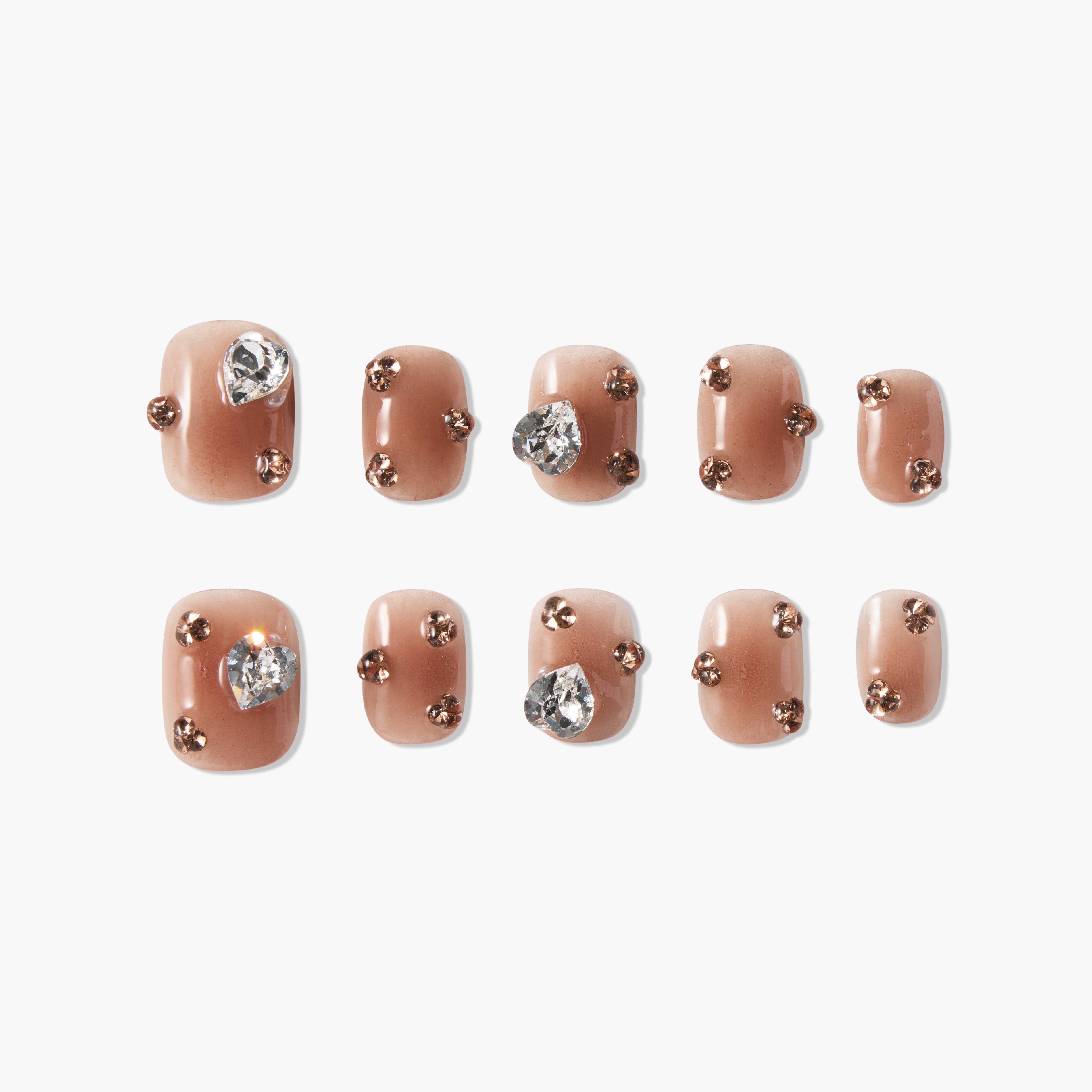 Brown press-on nails with rhinestone and gold stud accents, set on white background