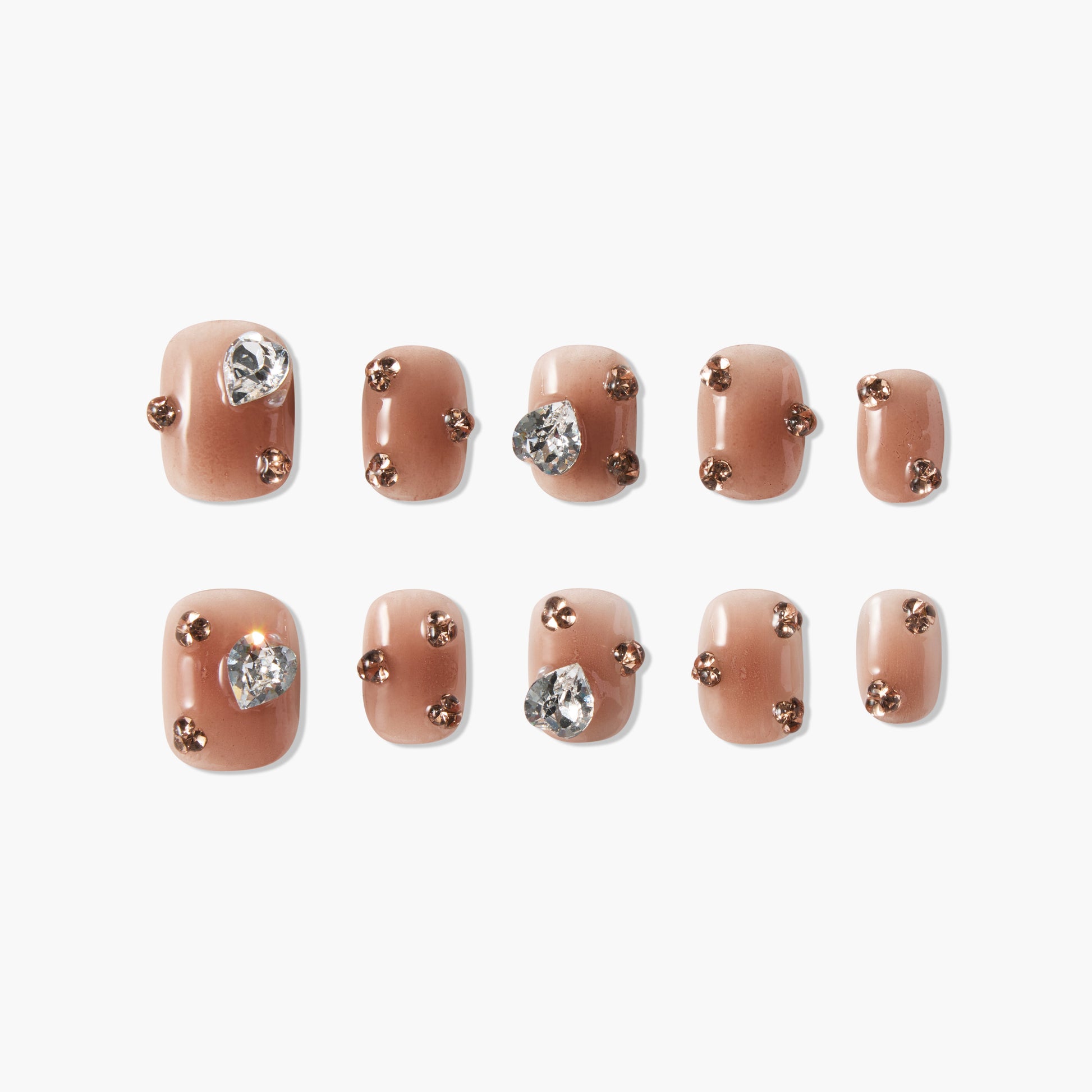 Brown press-on nails with rhinestone and gold stud accents, set on white background