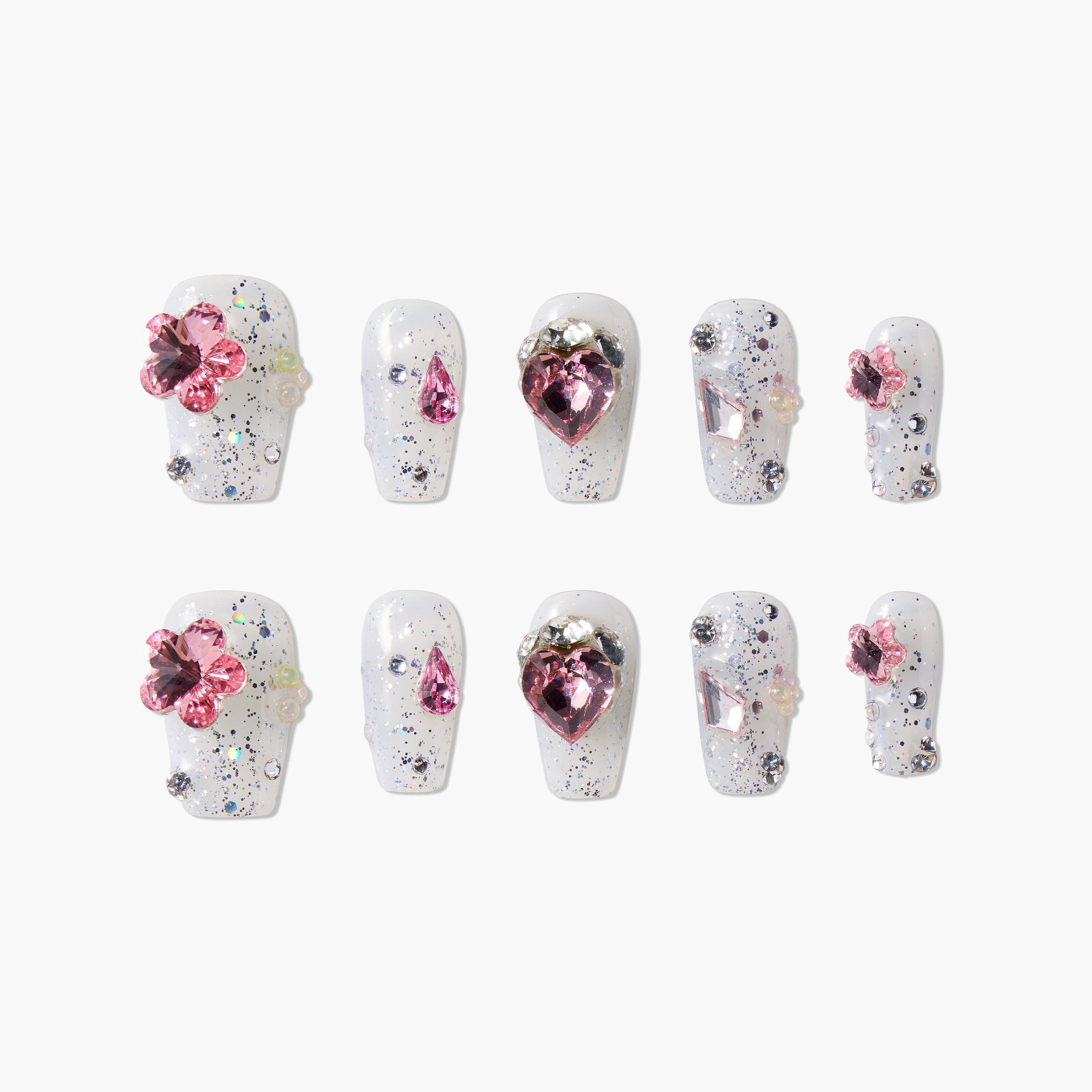 White glitter press-on nails with pink gemstone accents and 3D floral designs