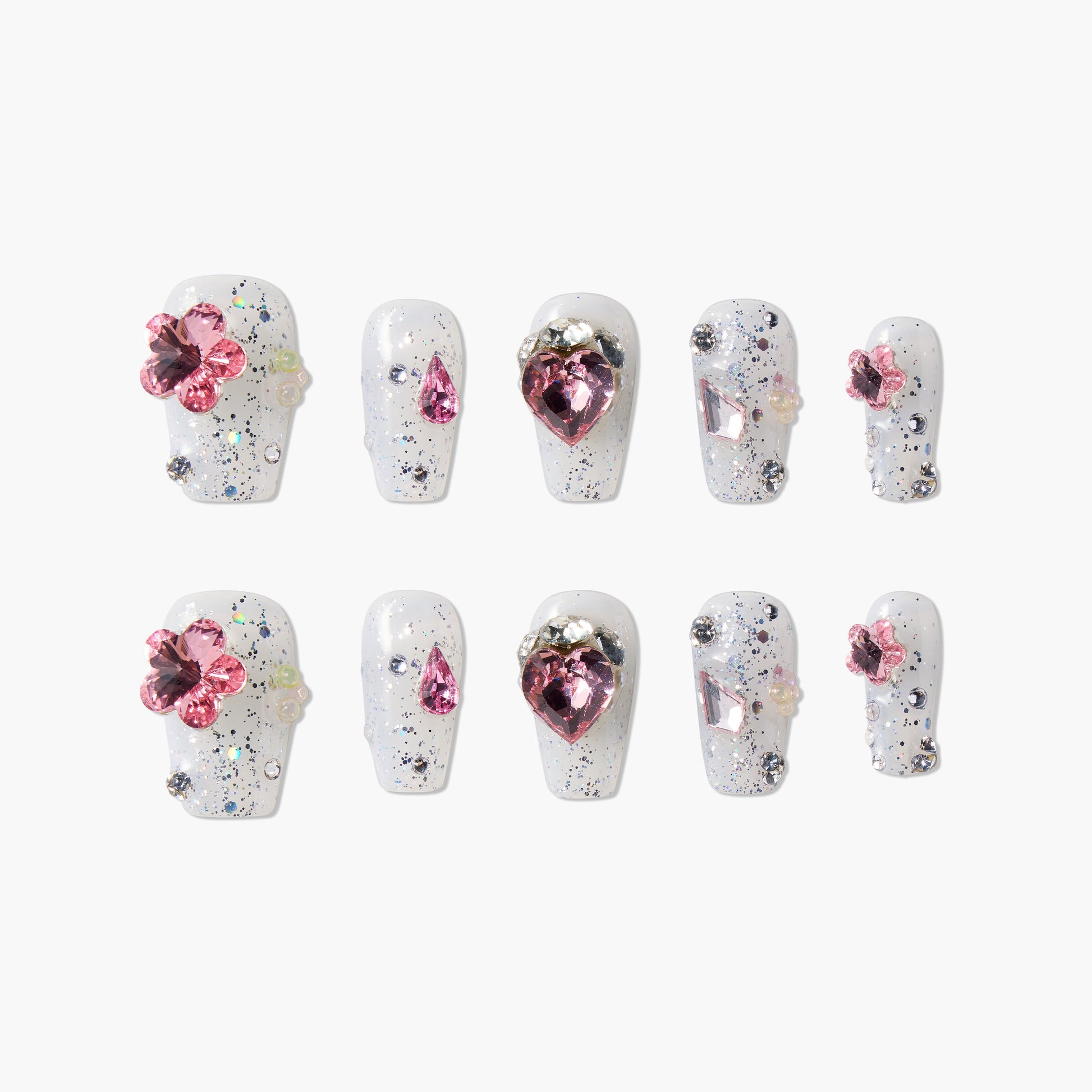 White glitter press-on nails with pink gemstone accents and 3D floral designs