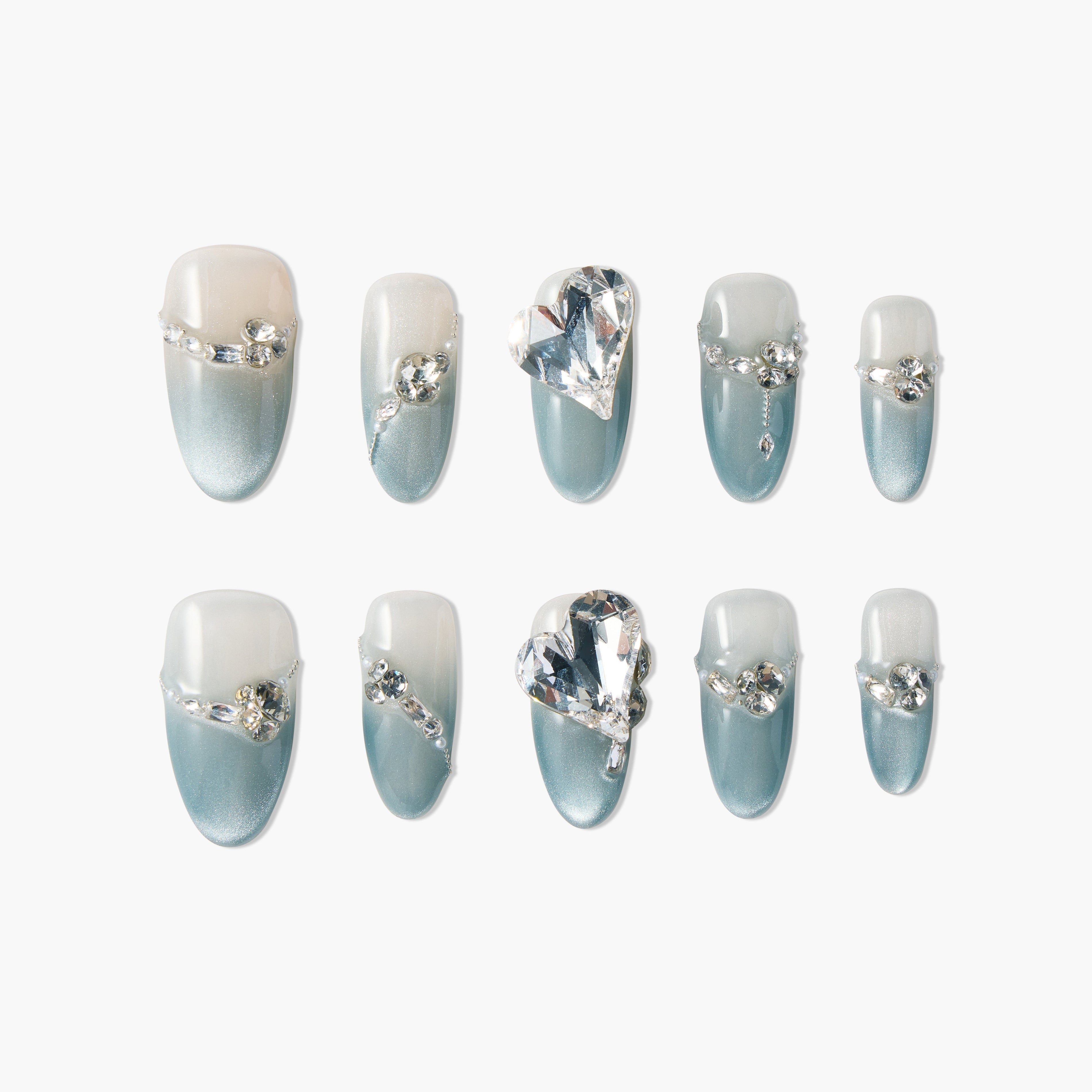 Blue and white gradient press-on nails with rhinestone and heart gem accents, luxury nail design