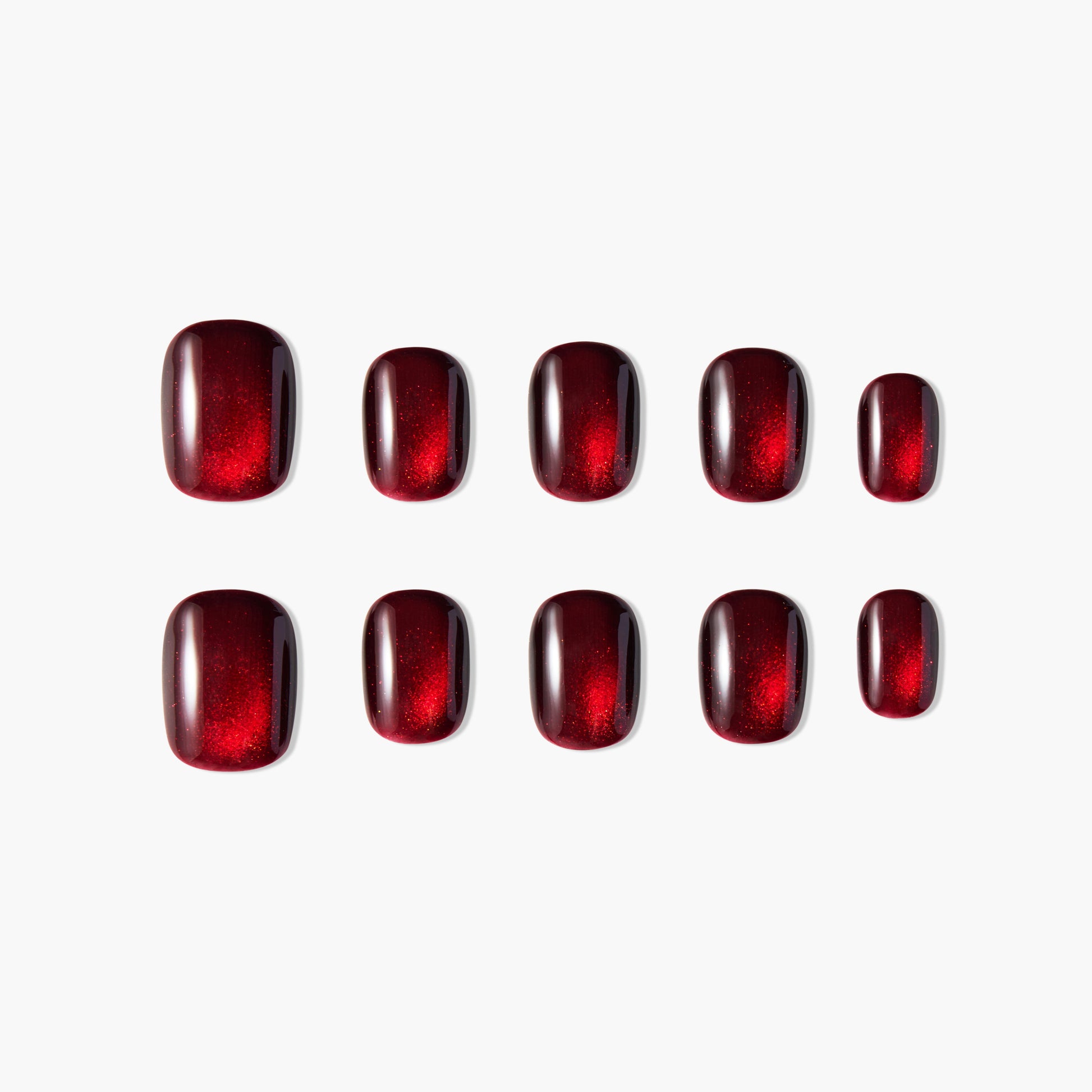 Set of glossy, deep red press-on nails with subtle shimmer on a white background