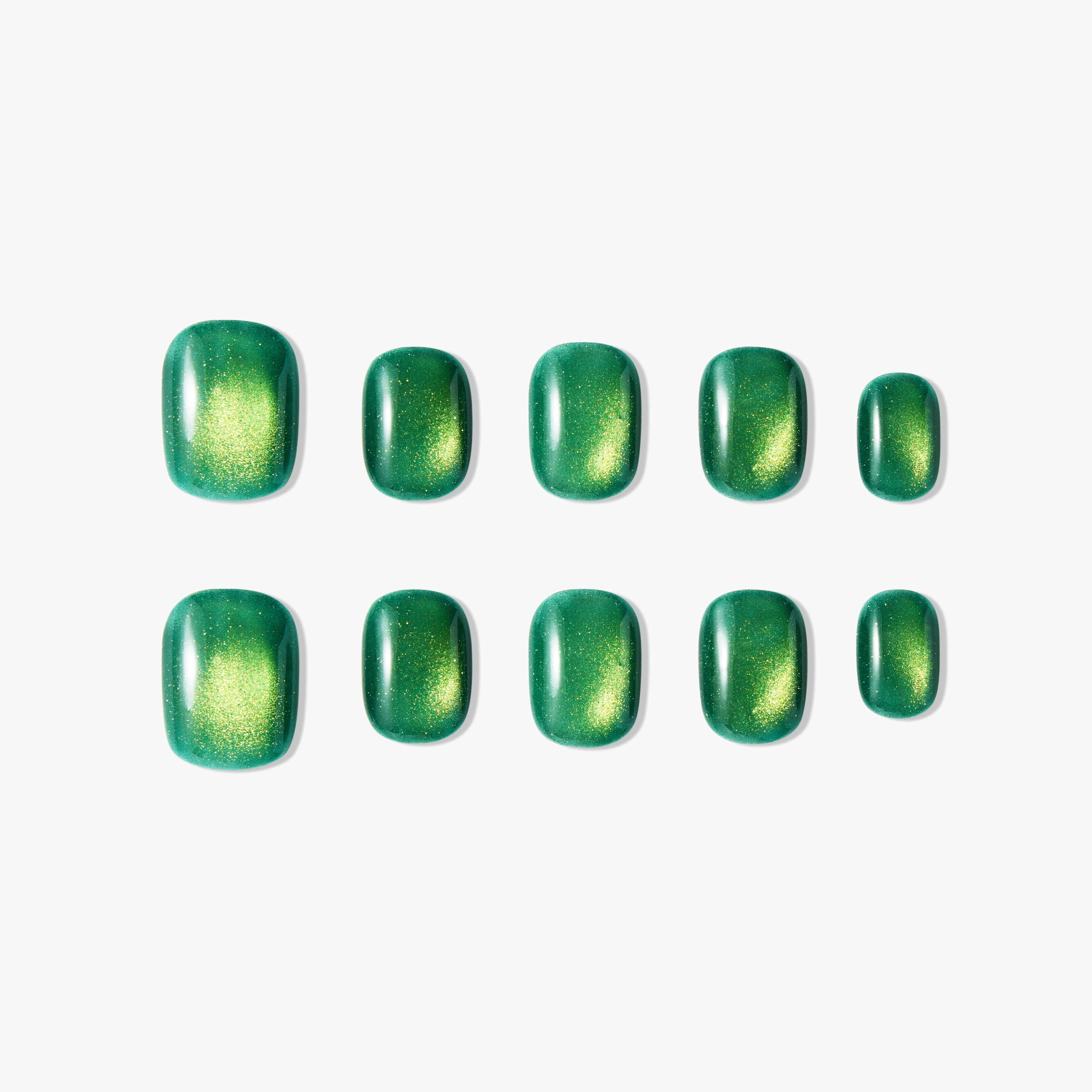 Glossy green press-on nails with metallic gold shimmer, arranged on a white background.